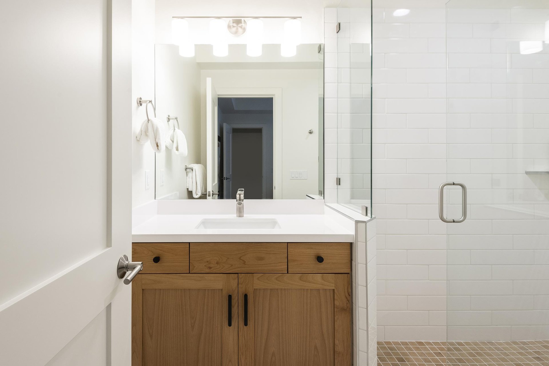34 bathroom with contemporary wooden cabinets and glass shower enclosure