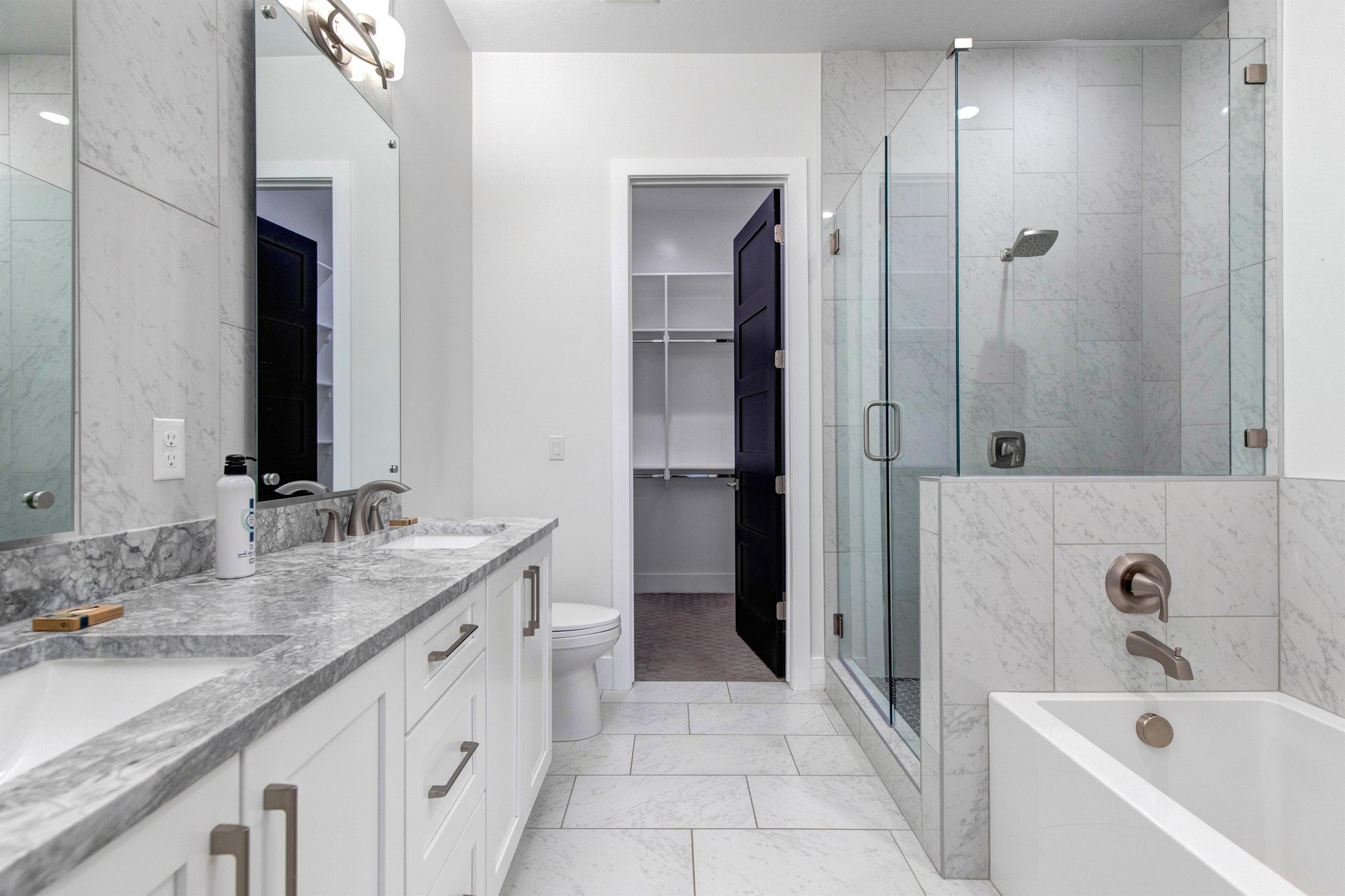 The en suite bathroom features a spacious walkin shower, elegant soaking tub, and premium finishes.