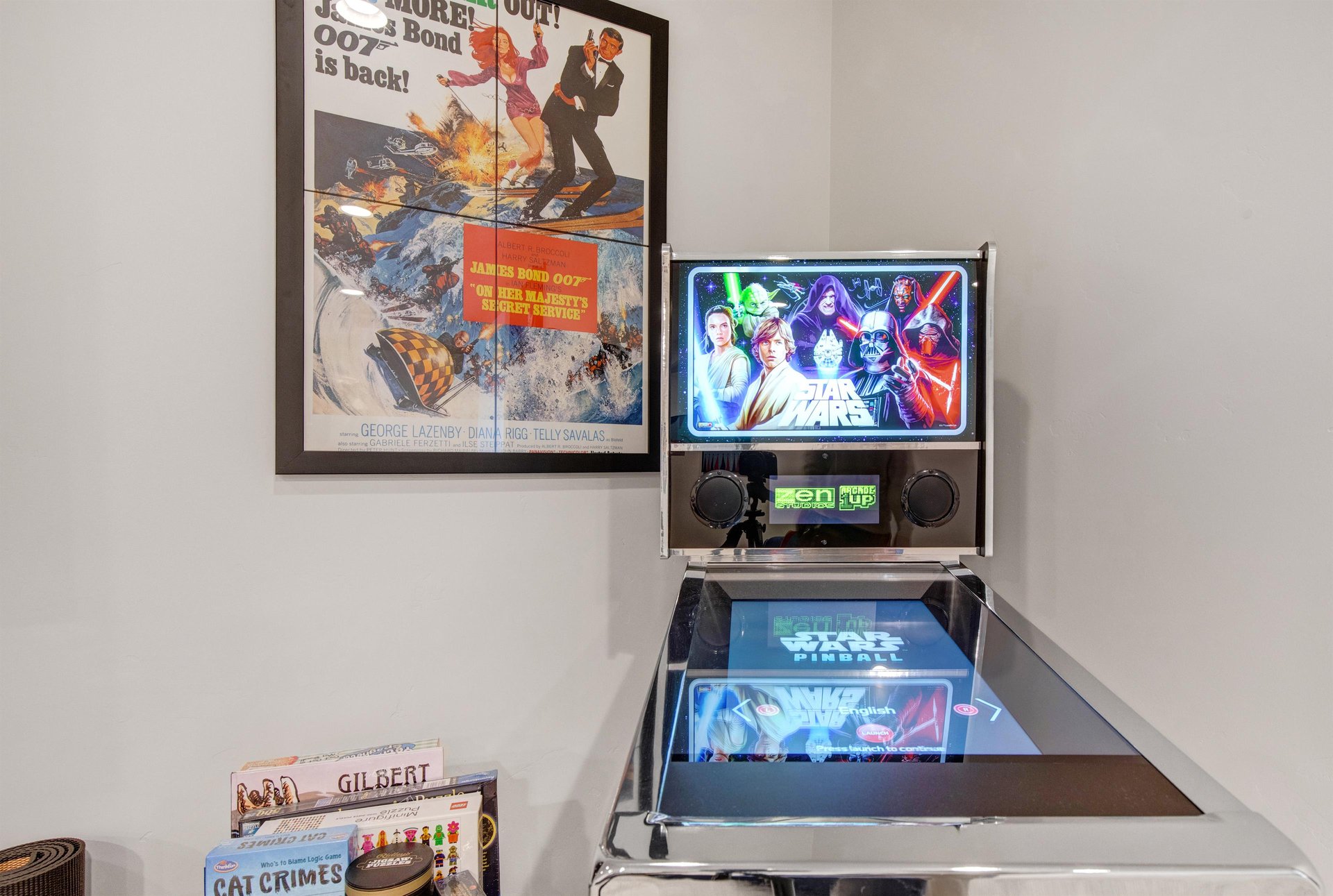 The game room complete with classic movie posters and vintage arcade vibes.