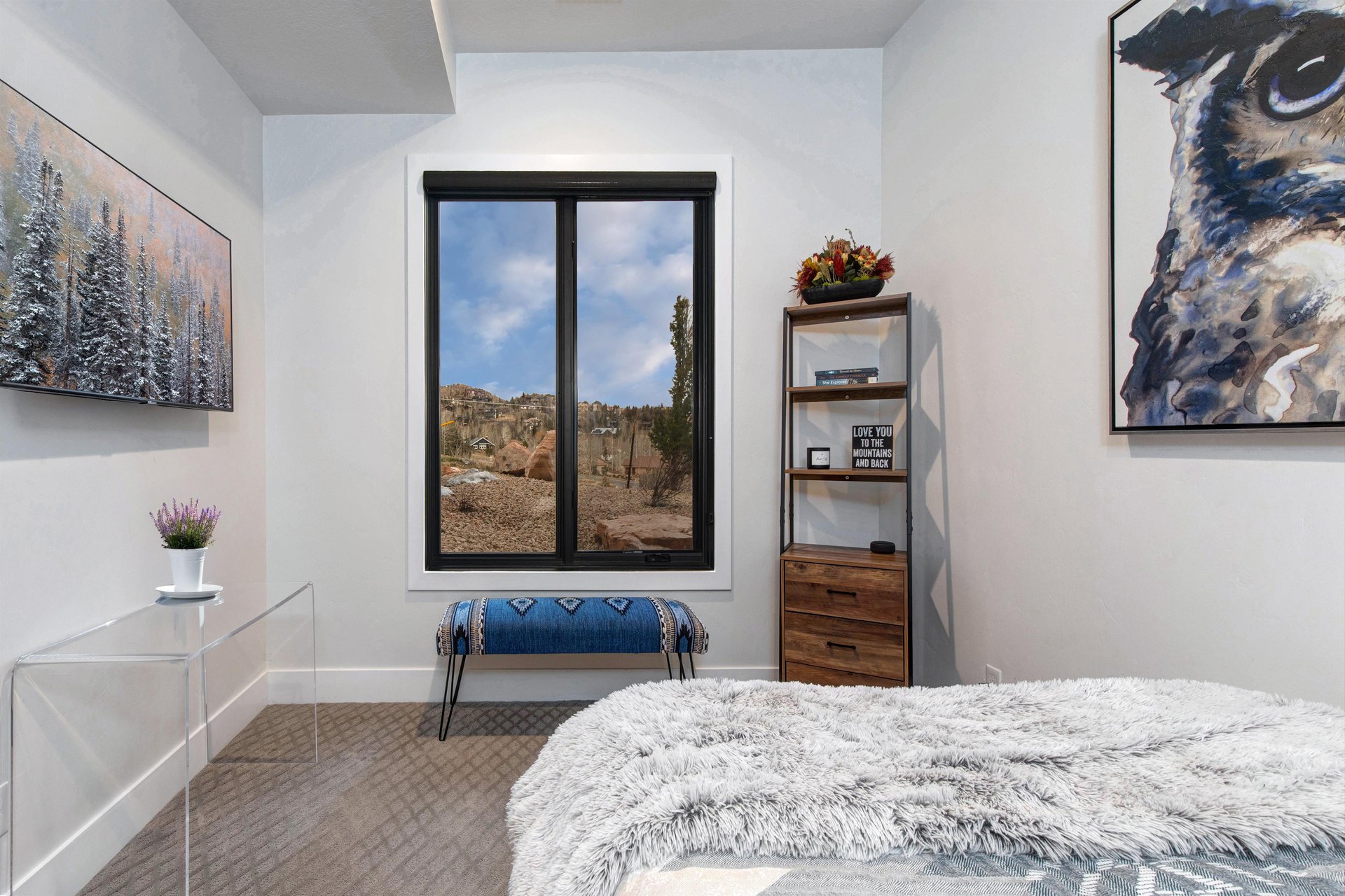 Relax in your serene bedroom featuring modern furnishings, original artwork, and a tranquil views.