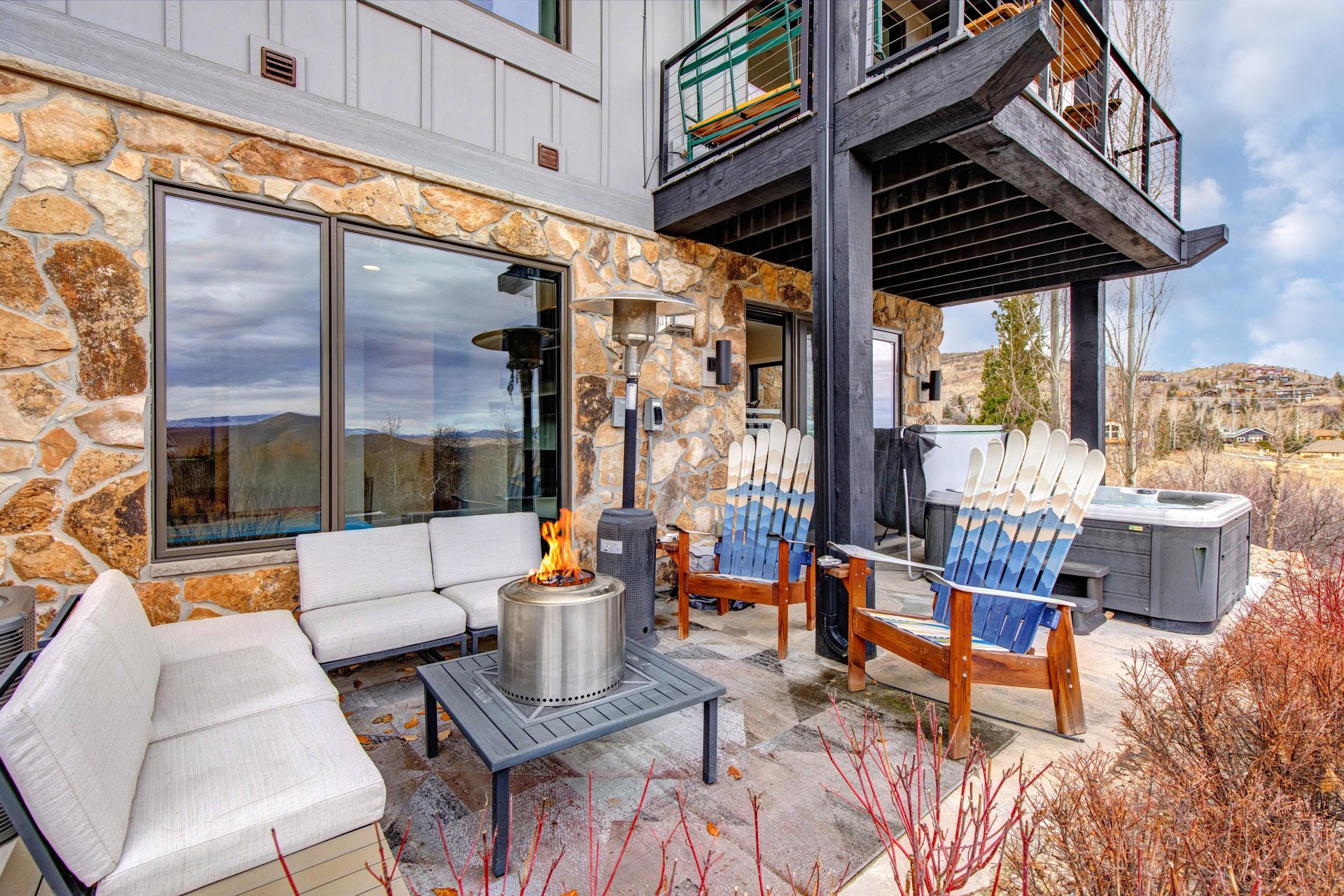 Your private patio features cozy seating around a crackling fire table.