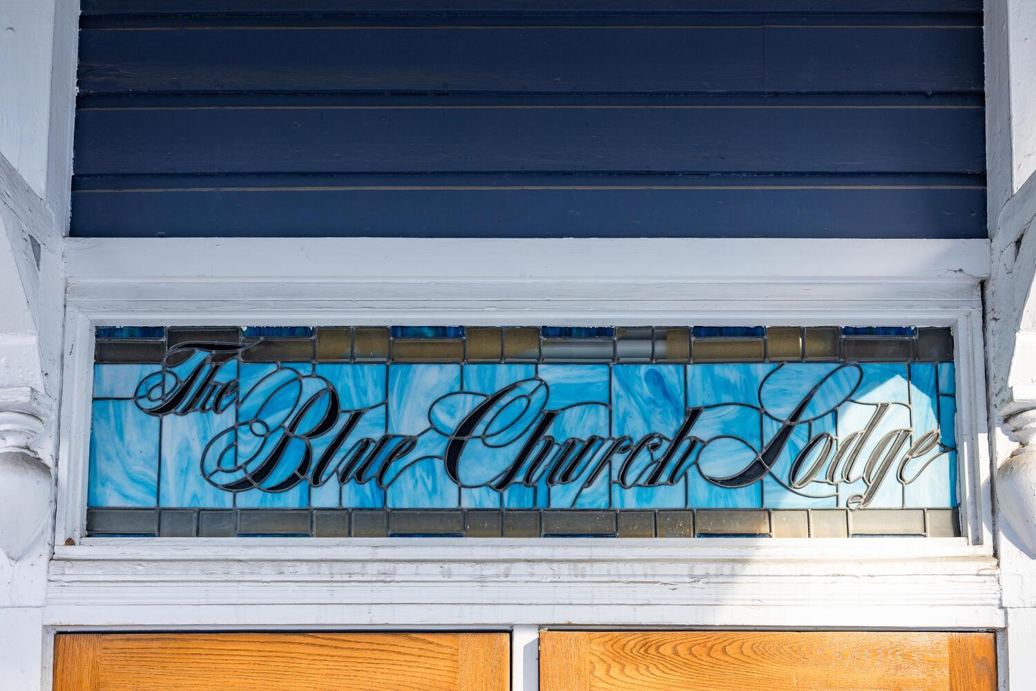 Blue Church Lodge stained glass on the exterior above the doros