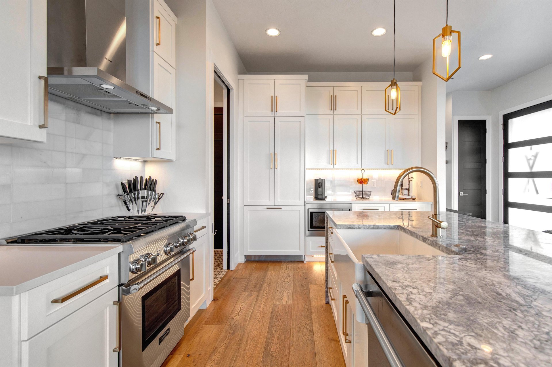 The kitchen has granite countertops, stainless steel appliances, and white cabinets.