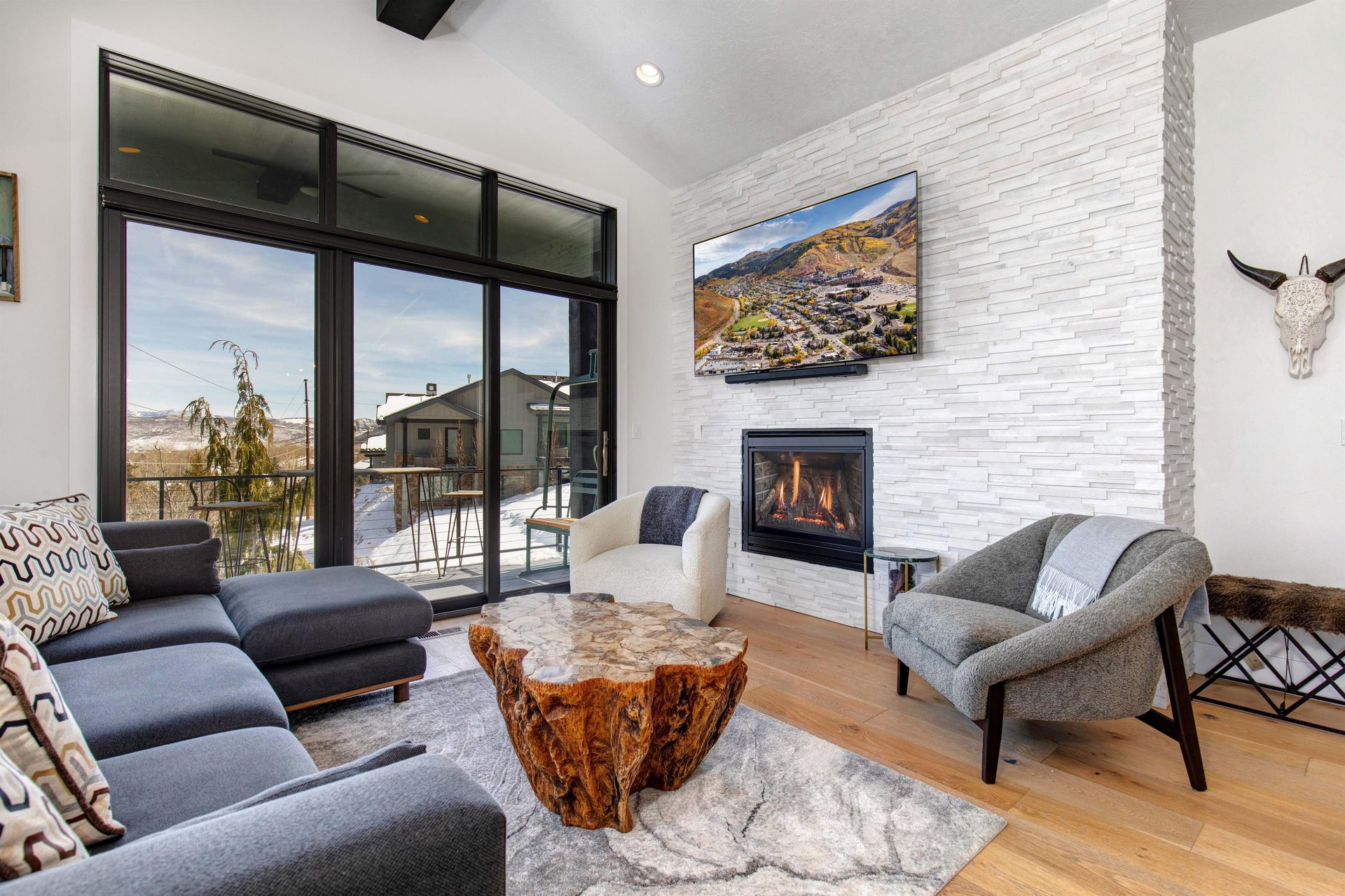 The cozy living room has a flatscreen TV, convenient gas burning fireplace, and modern furnishings.