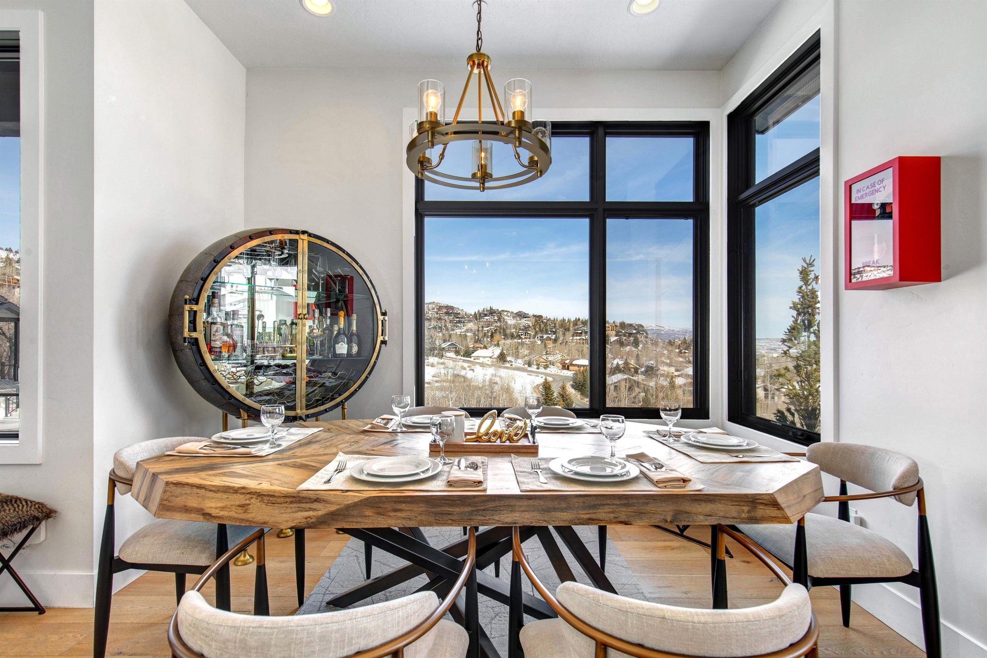 Gather around your elegant dining table while enjoying stunning mountain views through large windows.