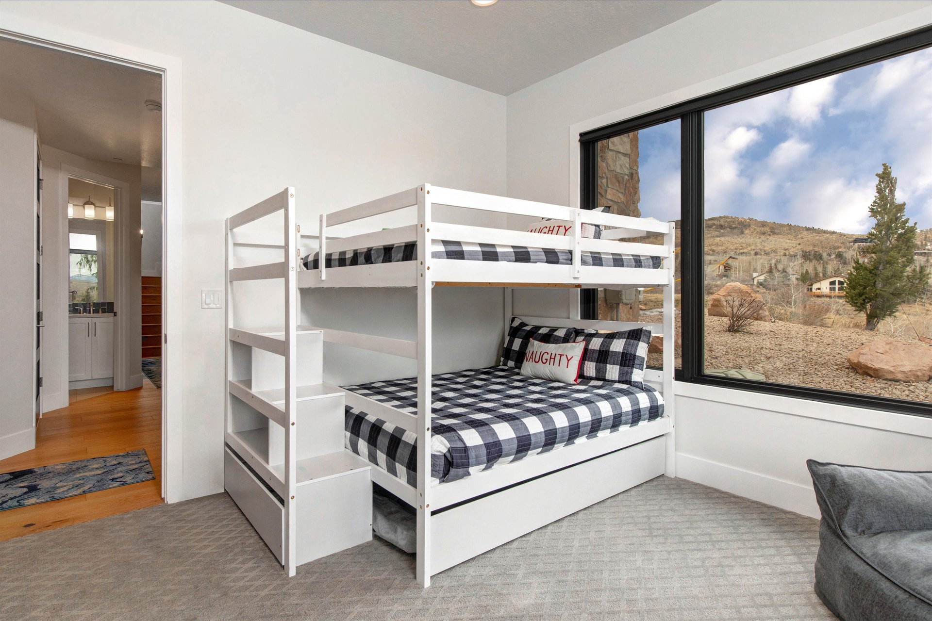 The cozy bunk room offers a queen bunk beds and a trundle bed.