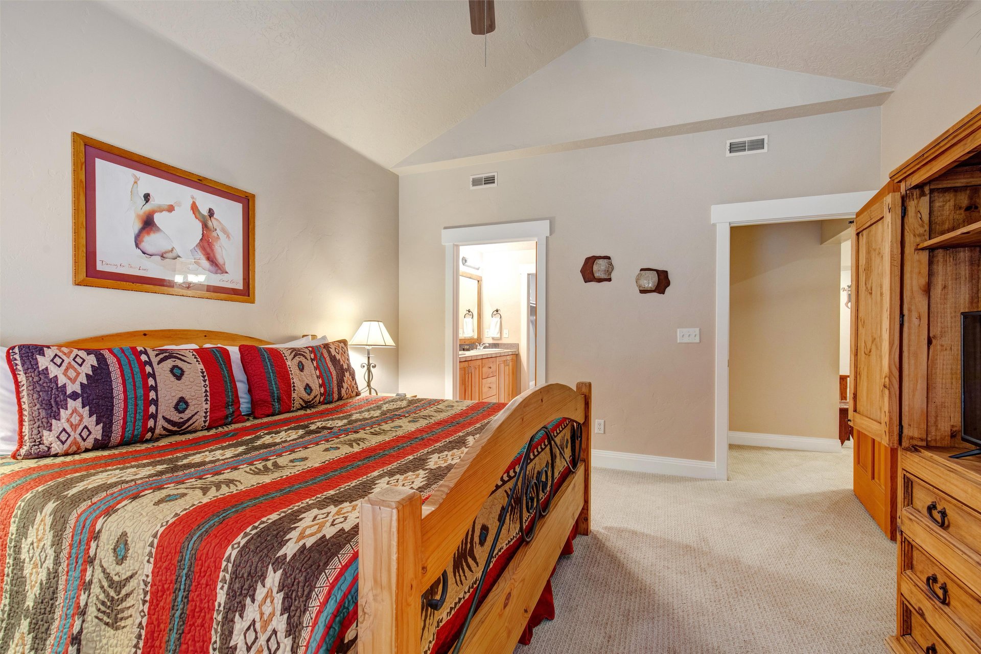 Wake up in your bright, vaulted bedroom where Southwestern charm meets comfort. With an ensuite bath steps away and stylish wood furniture, your mornings start peacefully.