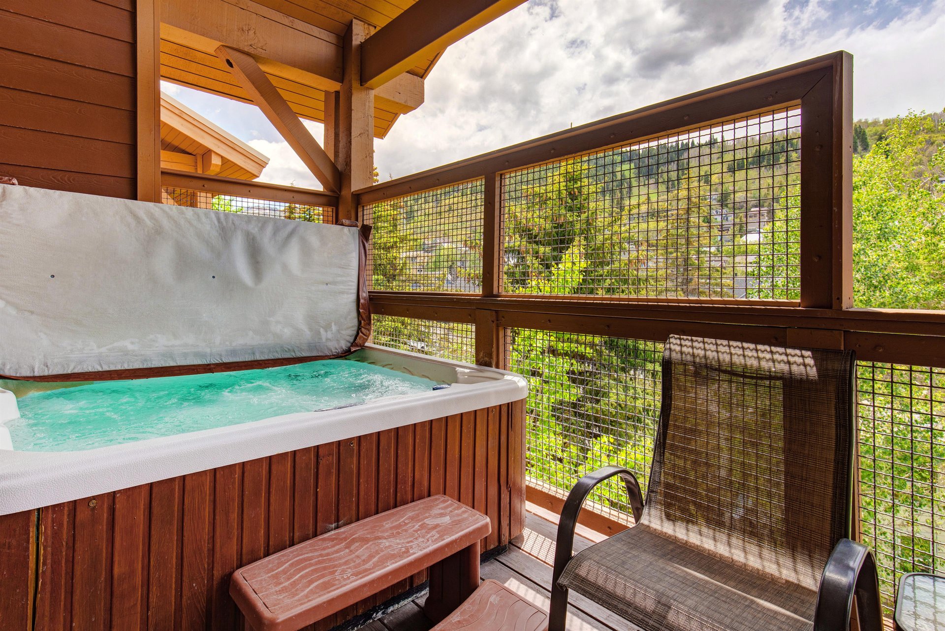 Unwind in your private hot tub on the covered deck, surrounded by lush forest views and open sky—a perfect retreat after a day of adventure.