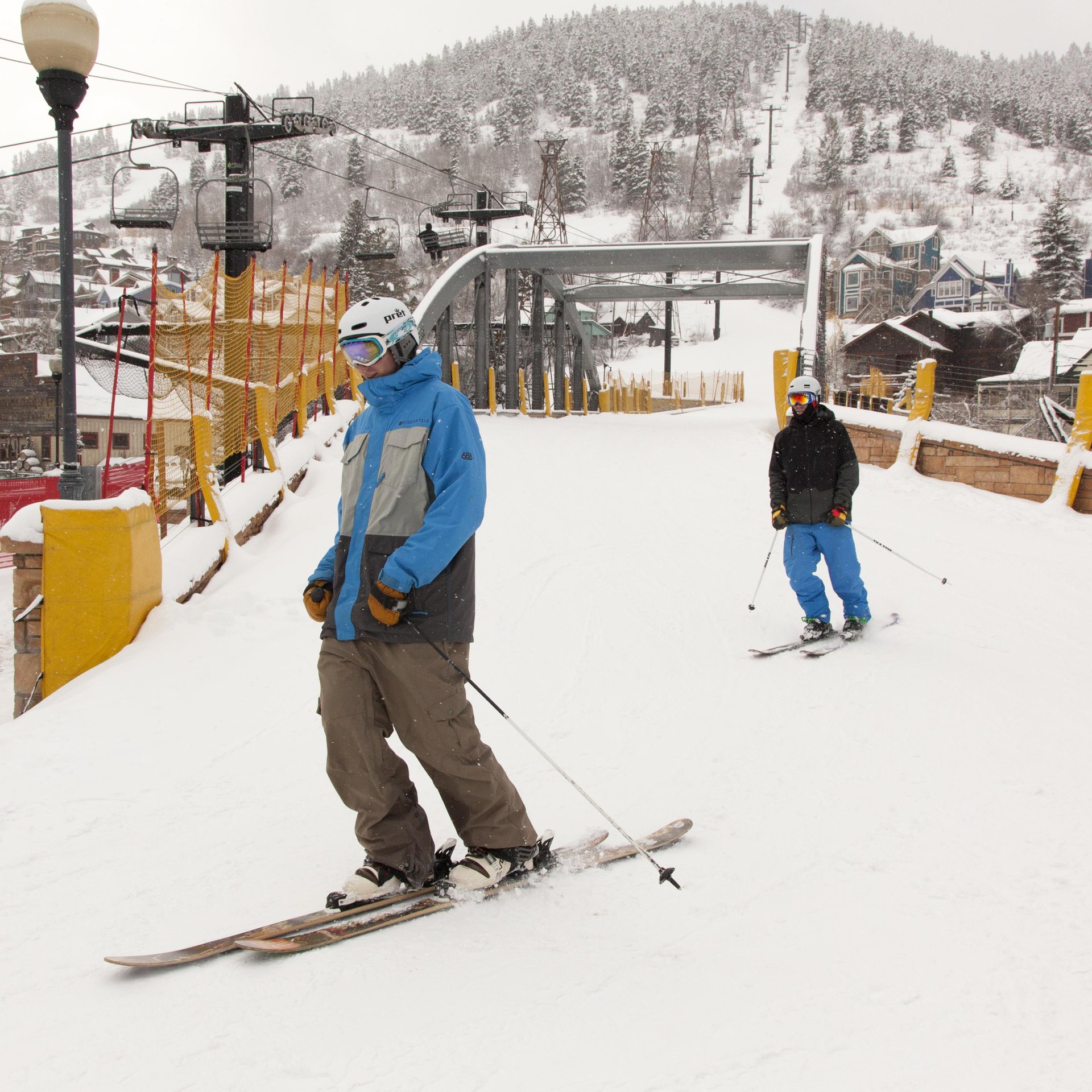 Skiinskiout access to snowcovered slopes with convenient lift access. Snowdusted alpine village and forested mountains frame the winter resort setting.