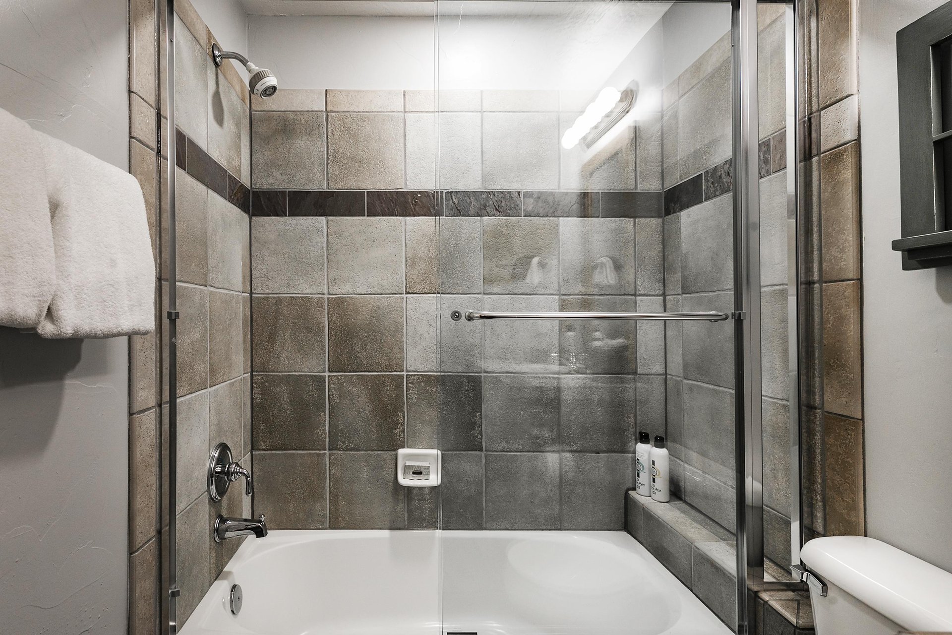 Shower tub combo in the final guest bathroom