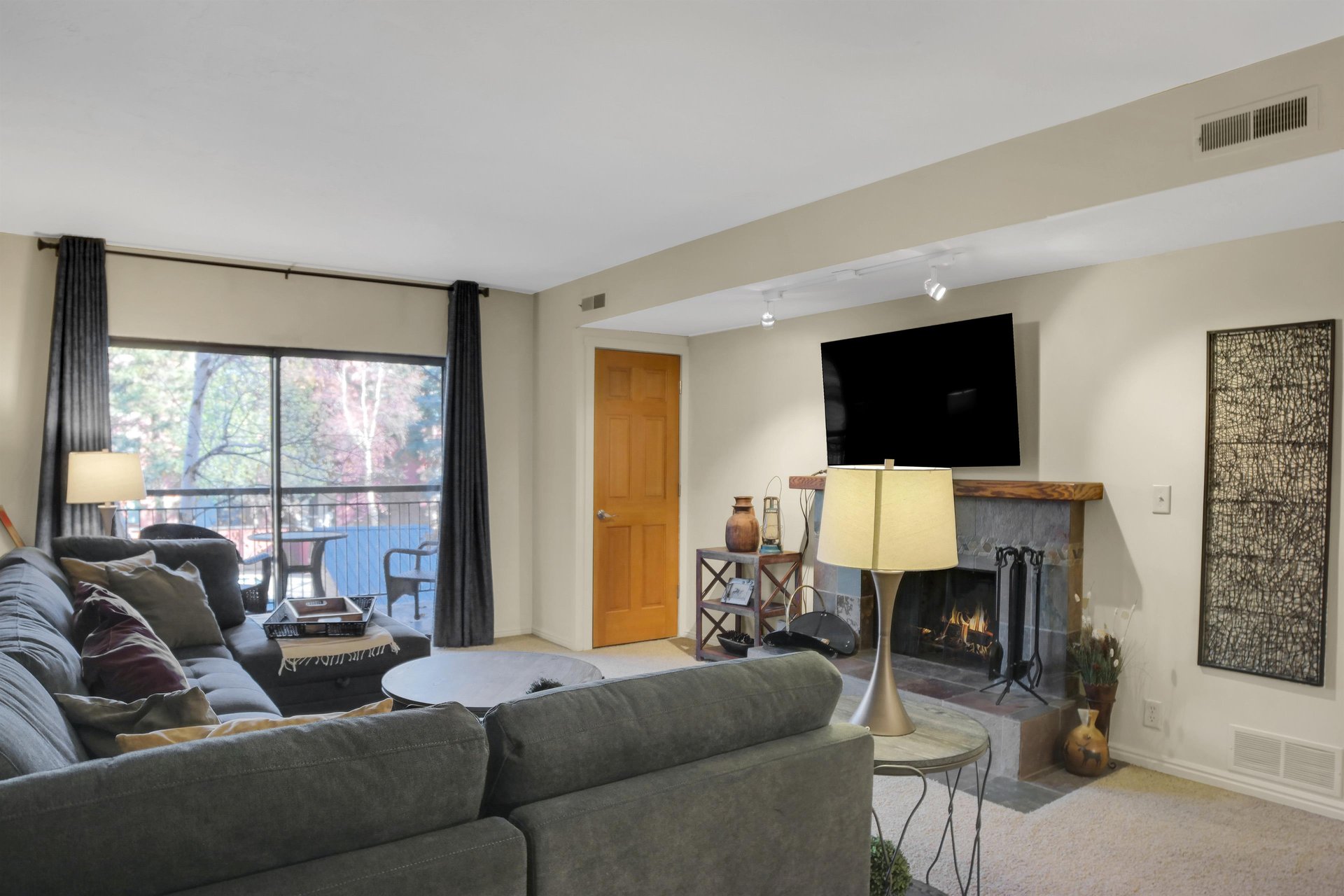 Park Station 122s living room has large sliding glass doors that lead to a patio.