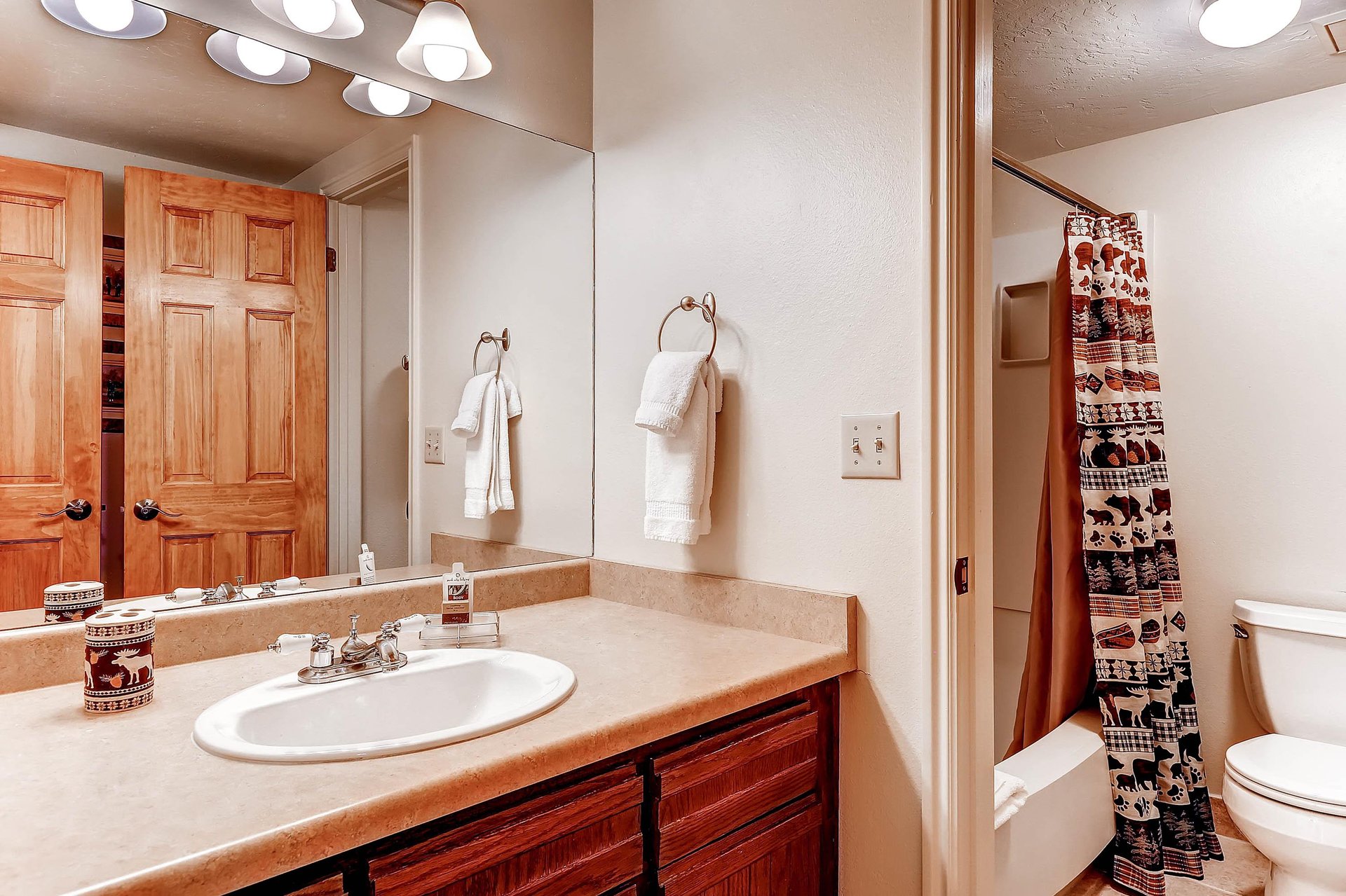 Park Station 122s bathroom has a one sink vanity, wood cabinets, and bathtubshower combination.