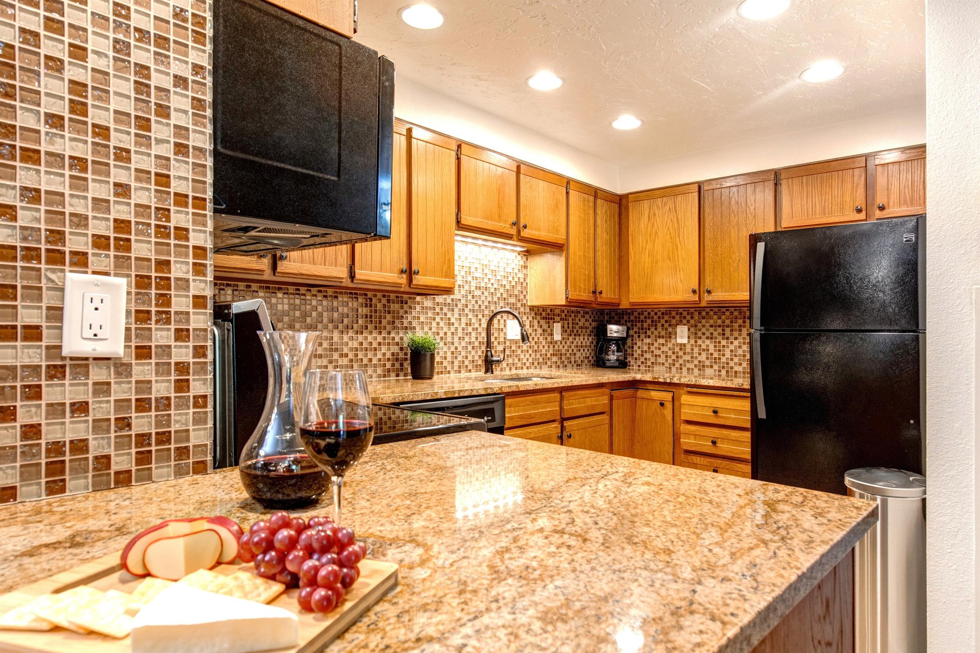 Park Station 124 has a well equipped kitchen with black appliances and wood cabinets.