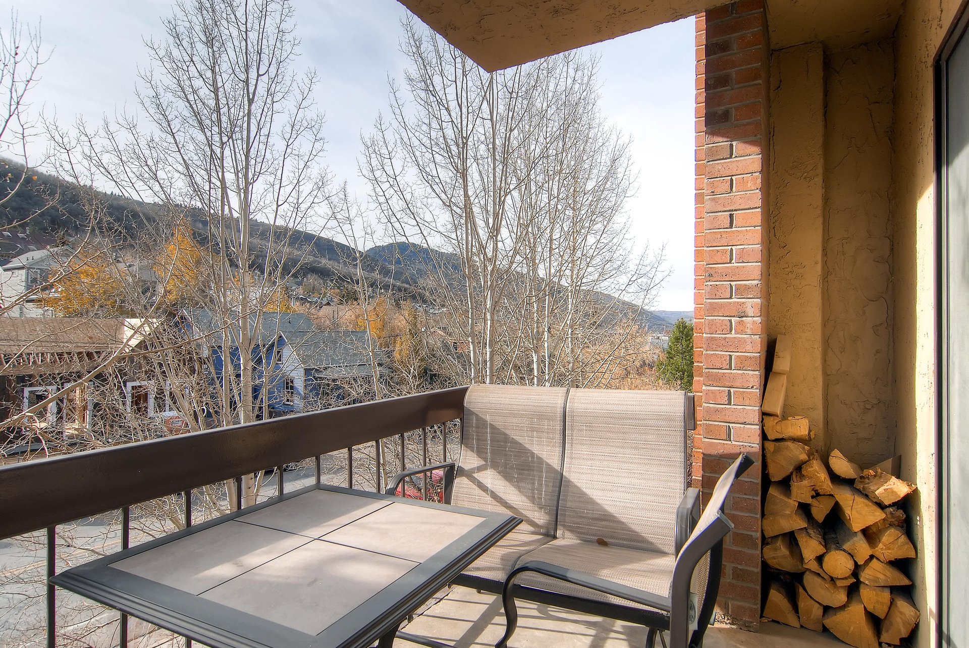 The private balcony offers mountain views and a sitting area.