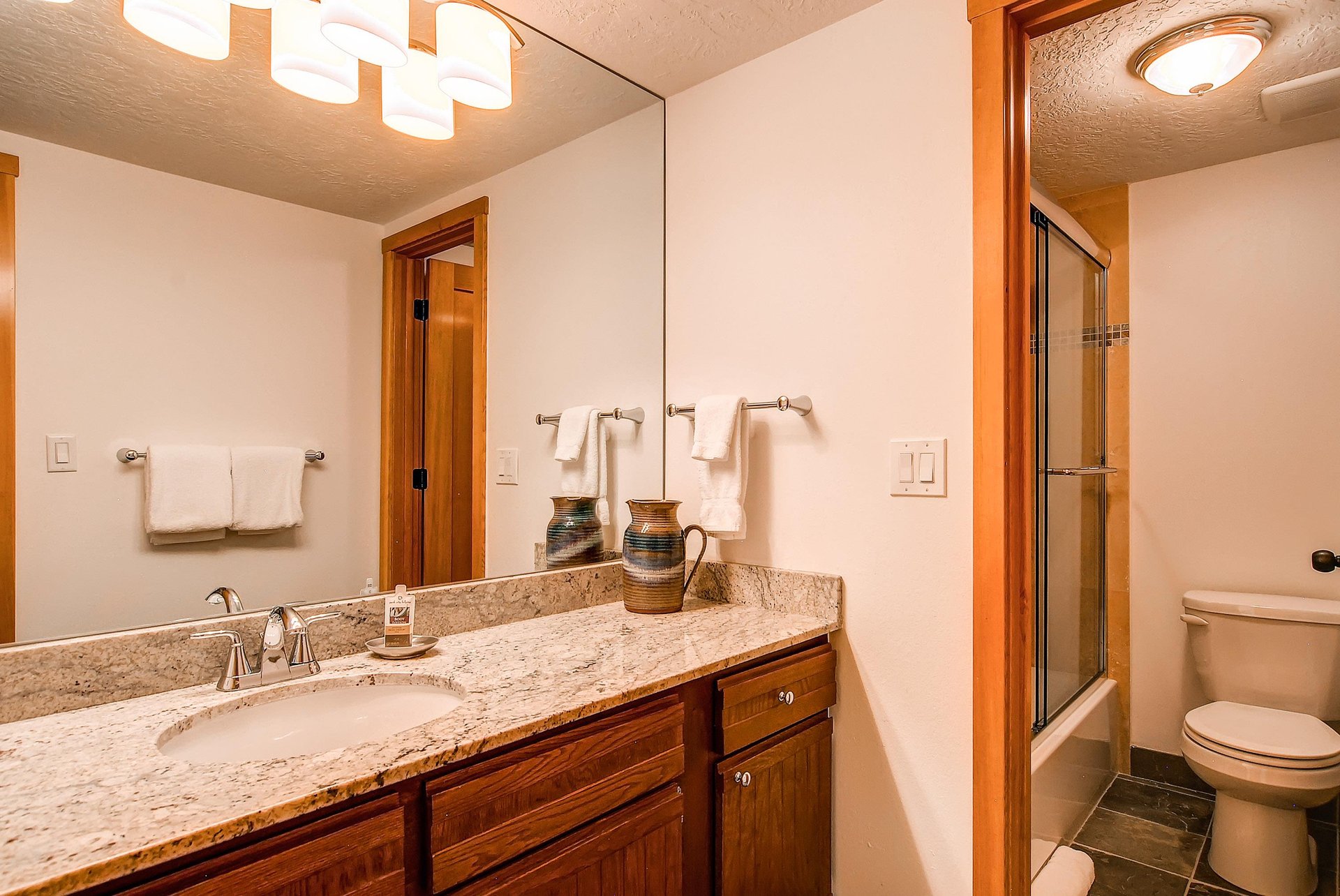 The shared bathroom has a single sink vanity and separate water closet.