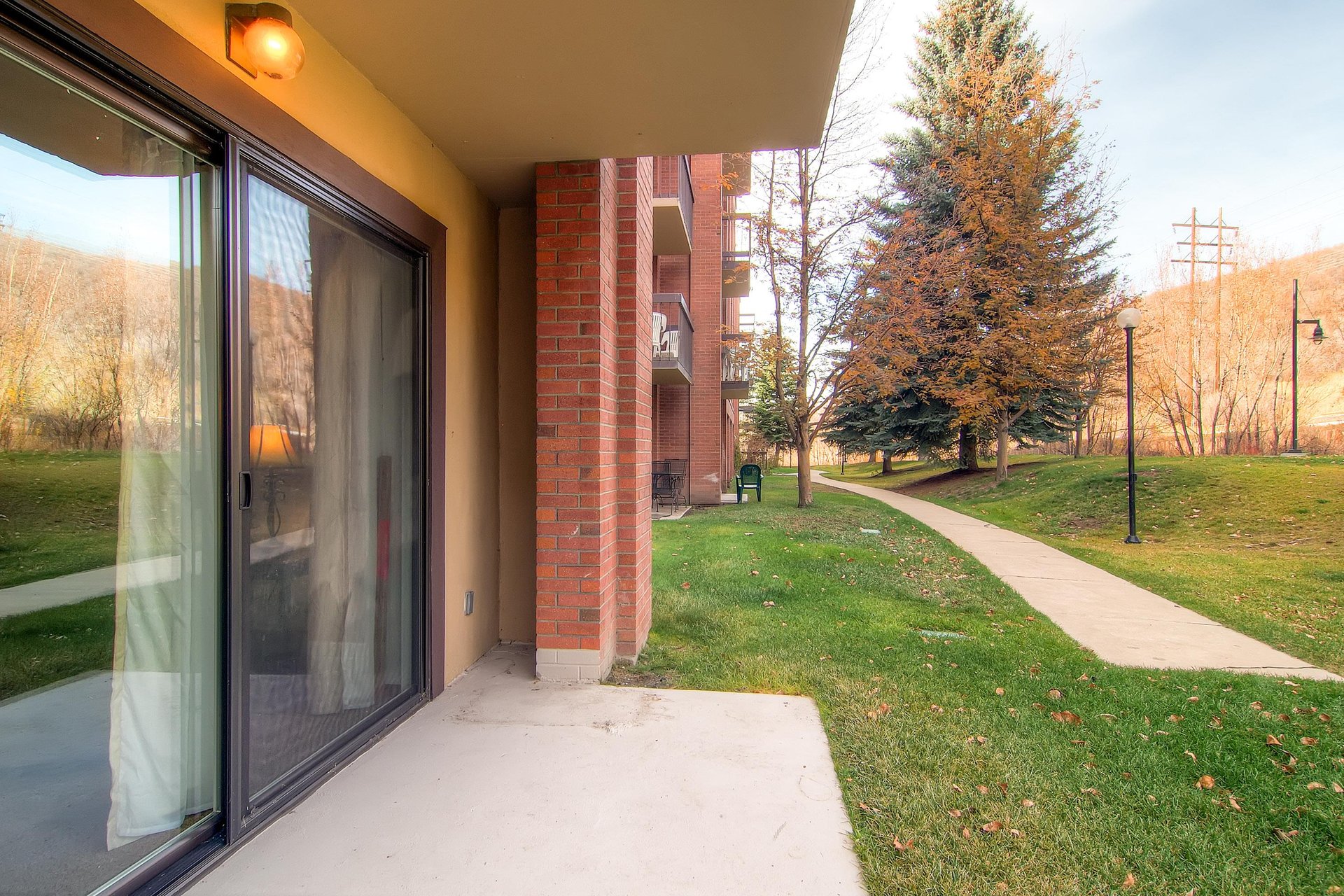 The private patio overlooks a lovely walking trail.