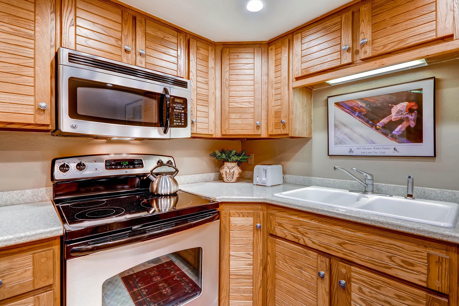 The wellequipped kitchen offers stainless steel appliances and wood cabinets.