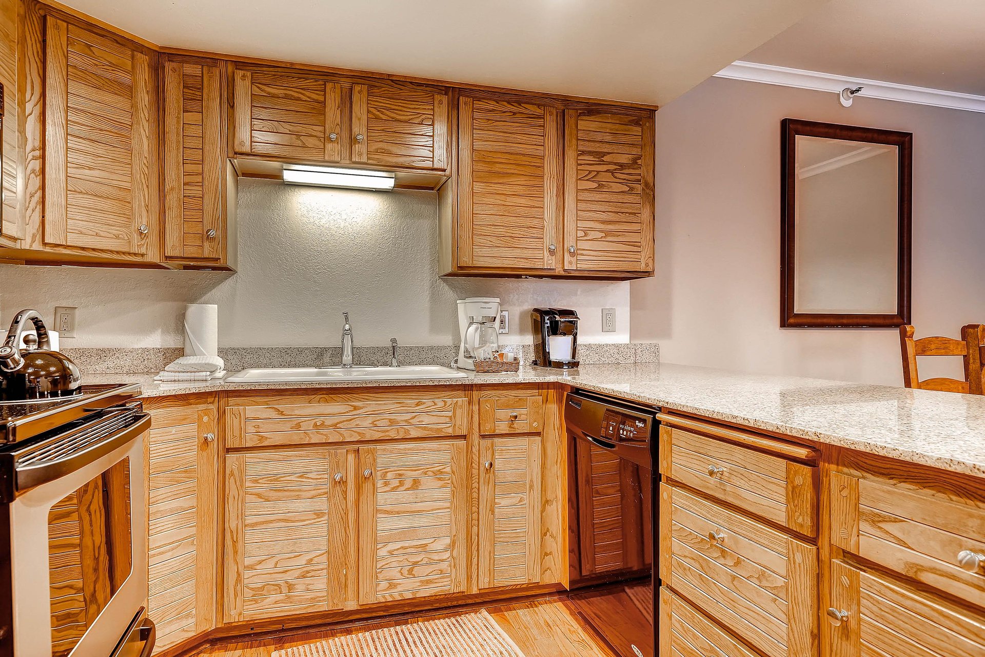 The wellequipped kitchen offers stainless steel appliances and wood cabinets.