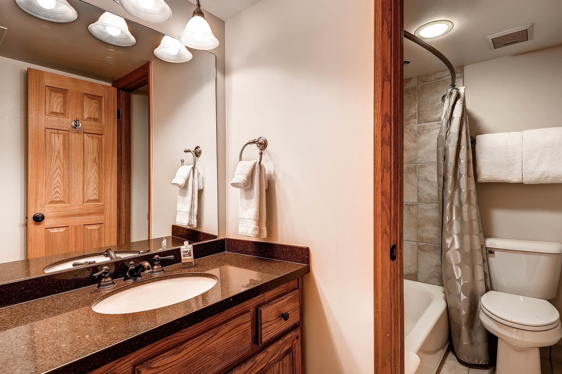 The shared bathroom has a single sink vanity and separate water closet.