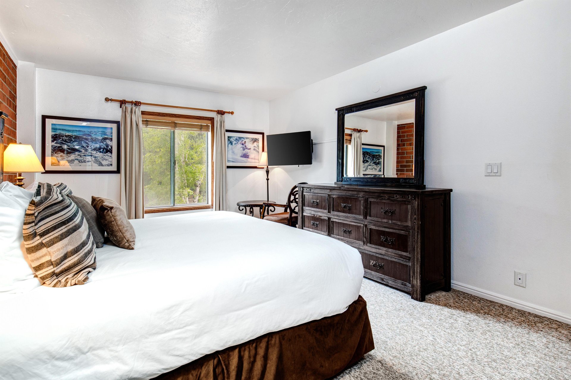 One of the bedrooms offers a kingsize bed and wood furniture.