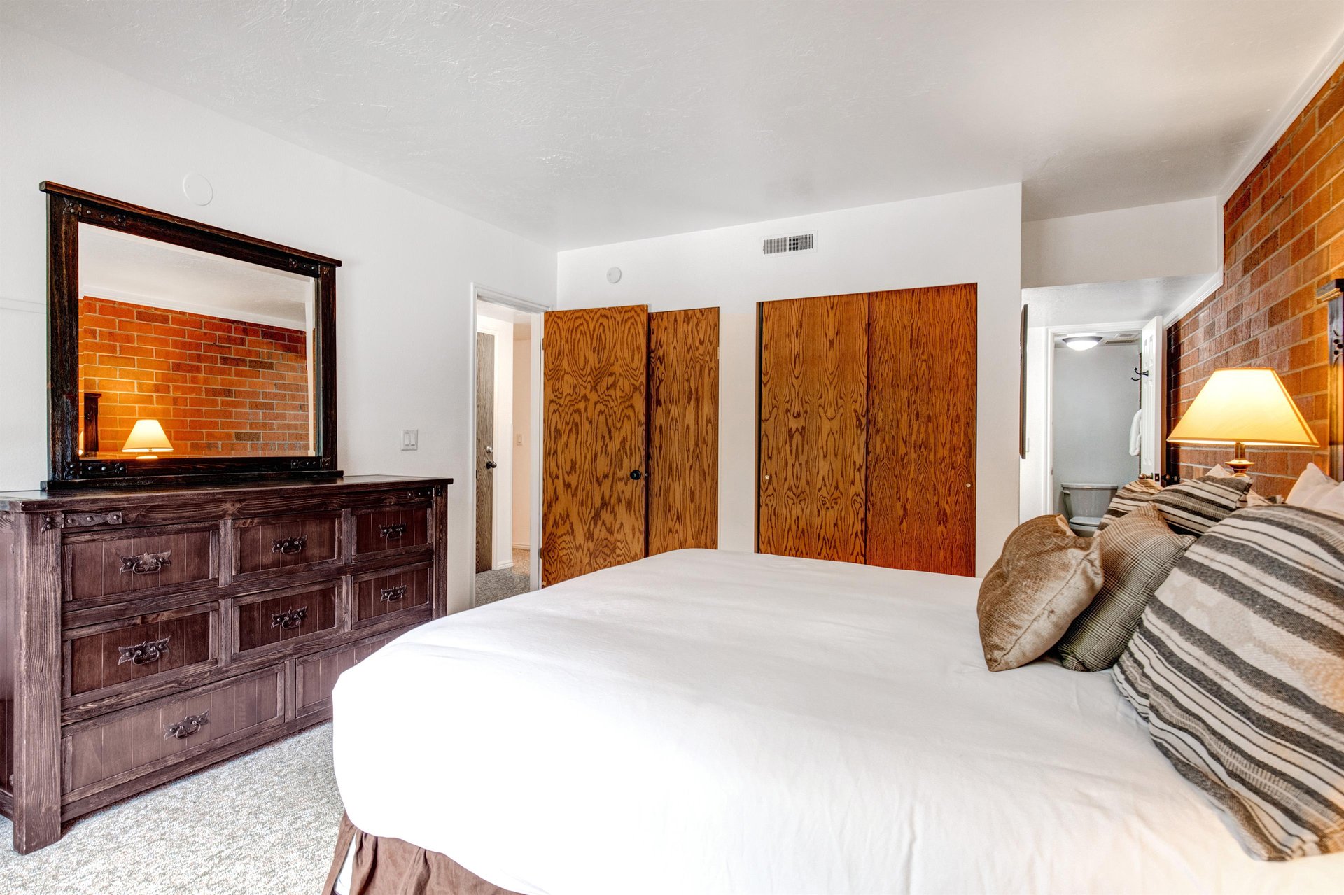 One of the bedrooms offers a kingsize bed and wood furniture.