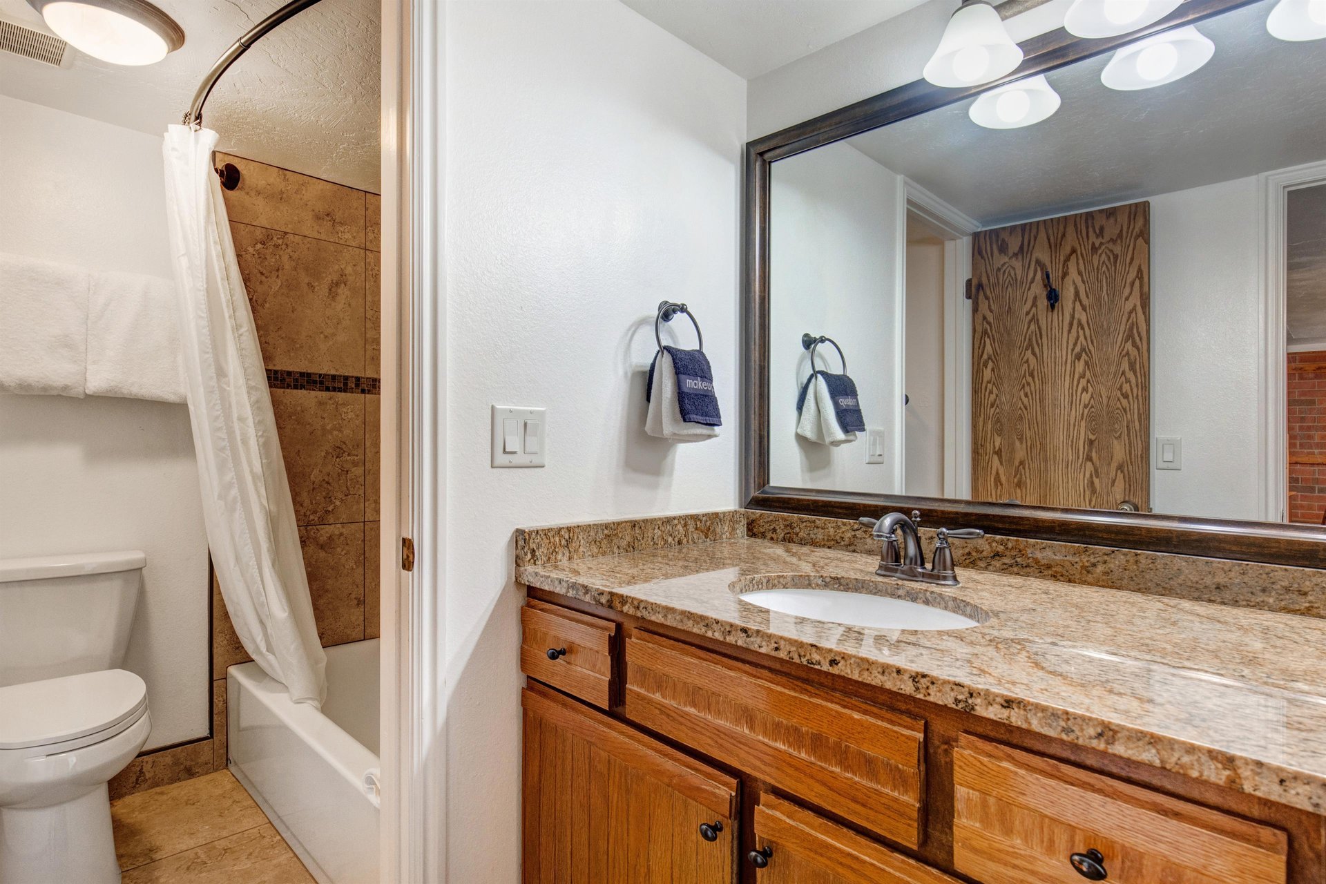 The shared bathroom has a single sink vanity and separate water closet.