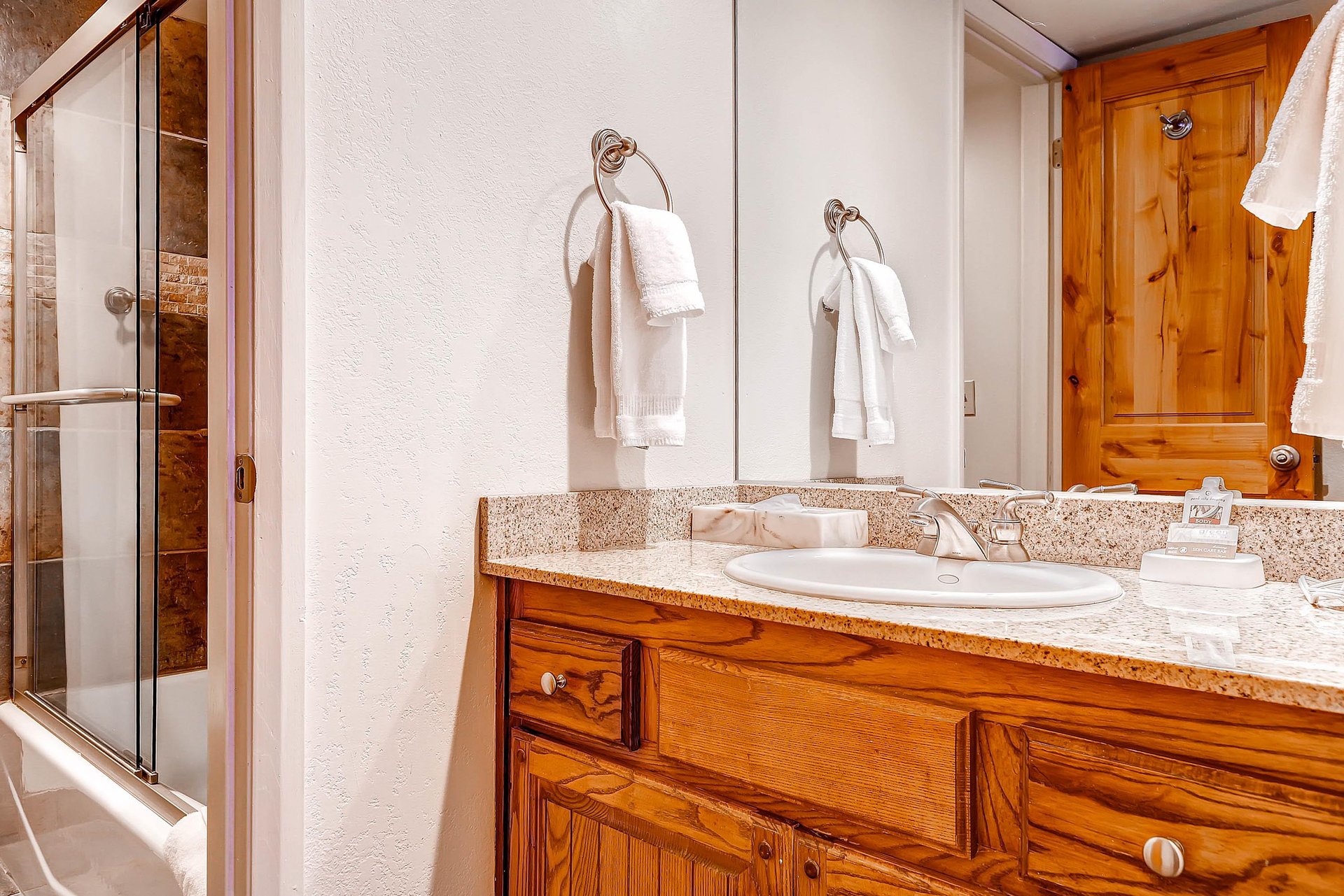 The en suite bathroom has a single sink vanity and separate water closet.