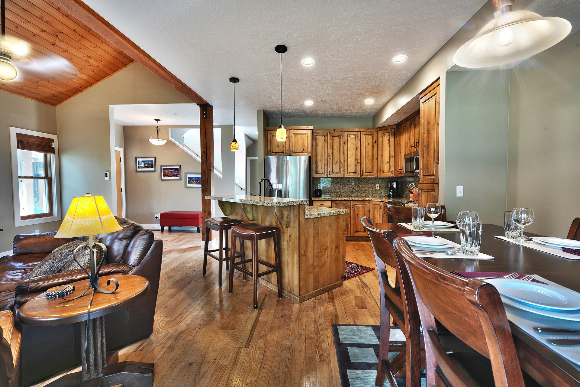 Dining, living, and kitchen area, vaulted ceilings on the main floor with hardwood floors throughout