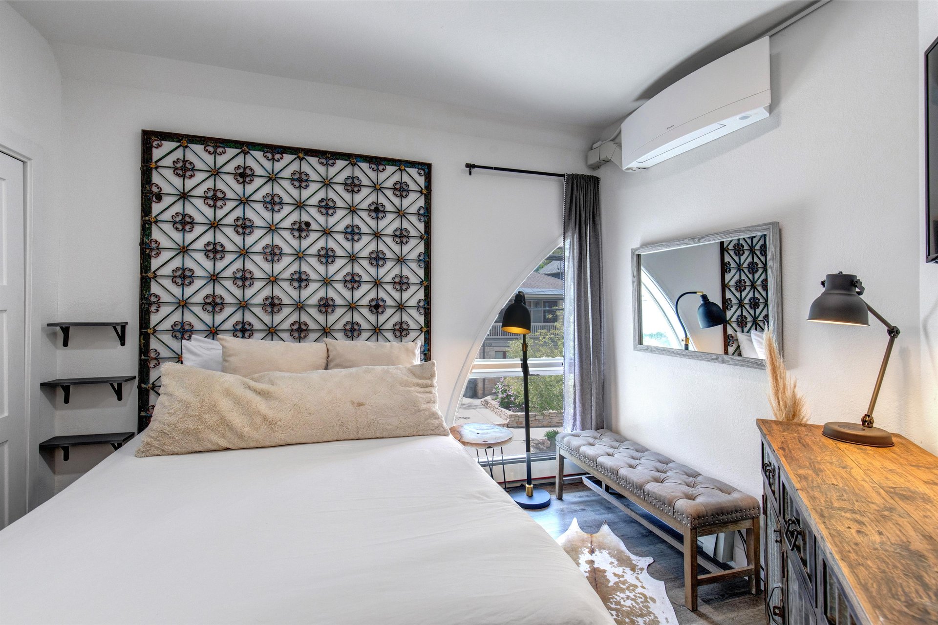 The main suite offers a queen size bed and stylish furnishings.