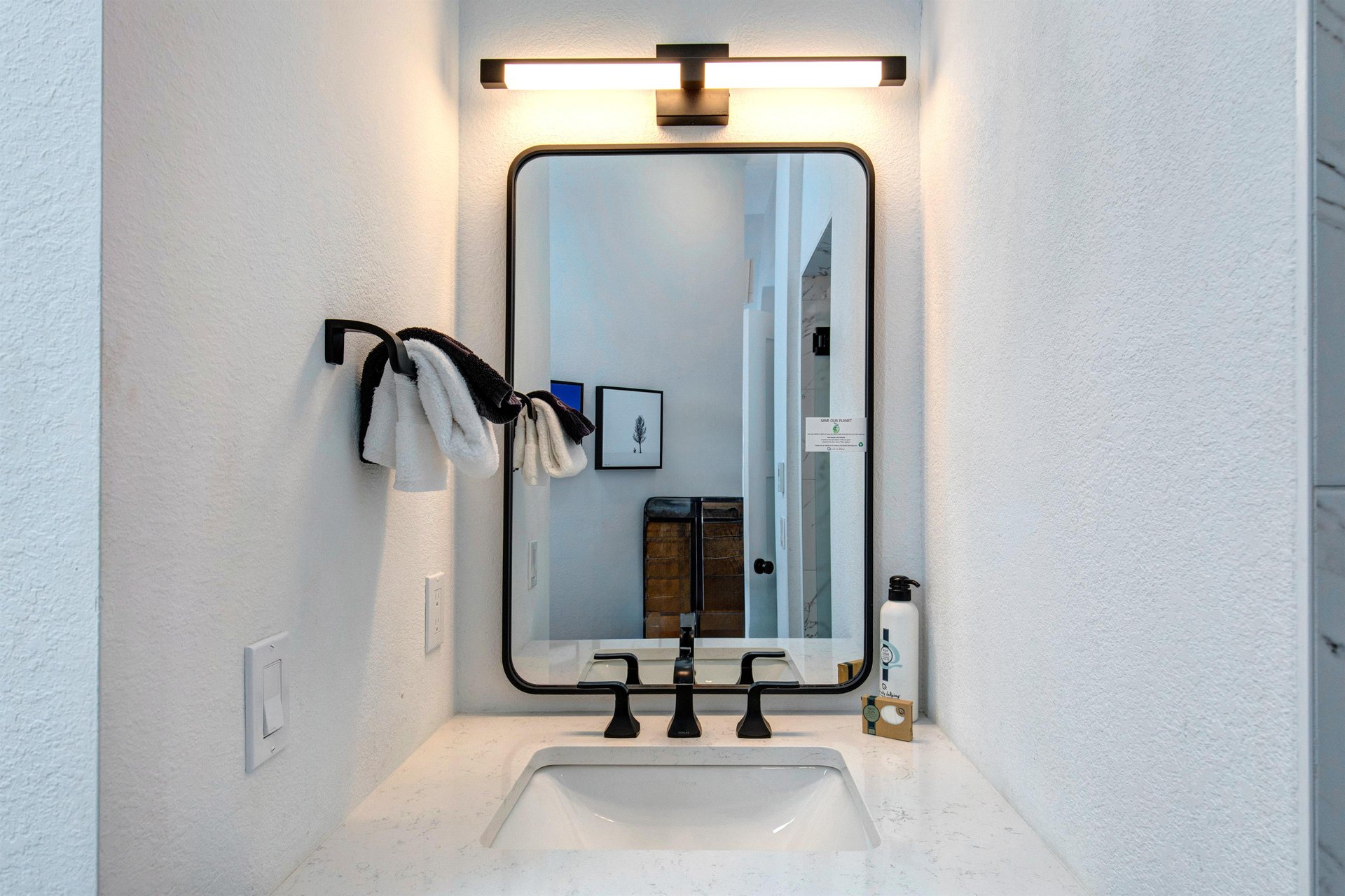 The attached bathroom with single sink vanity.