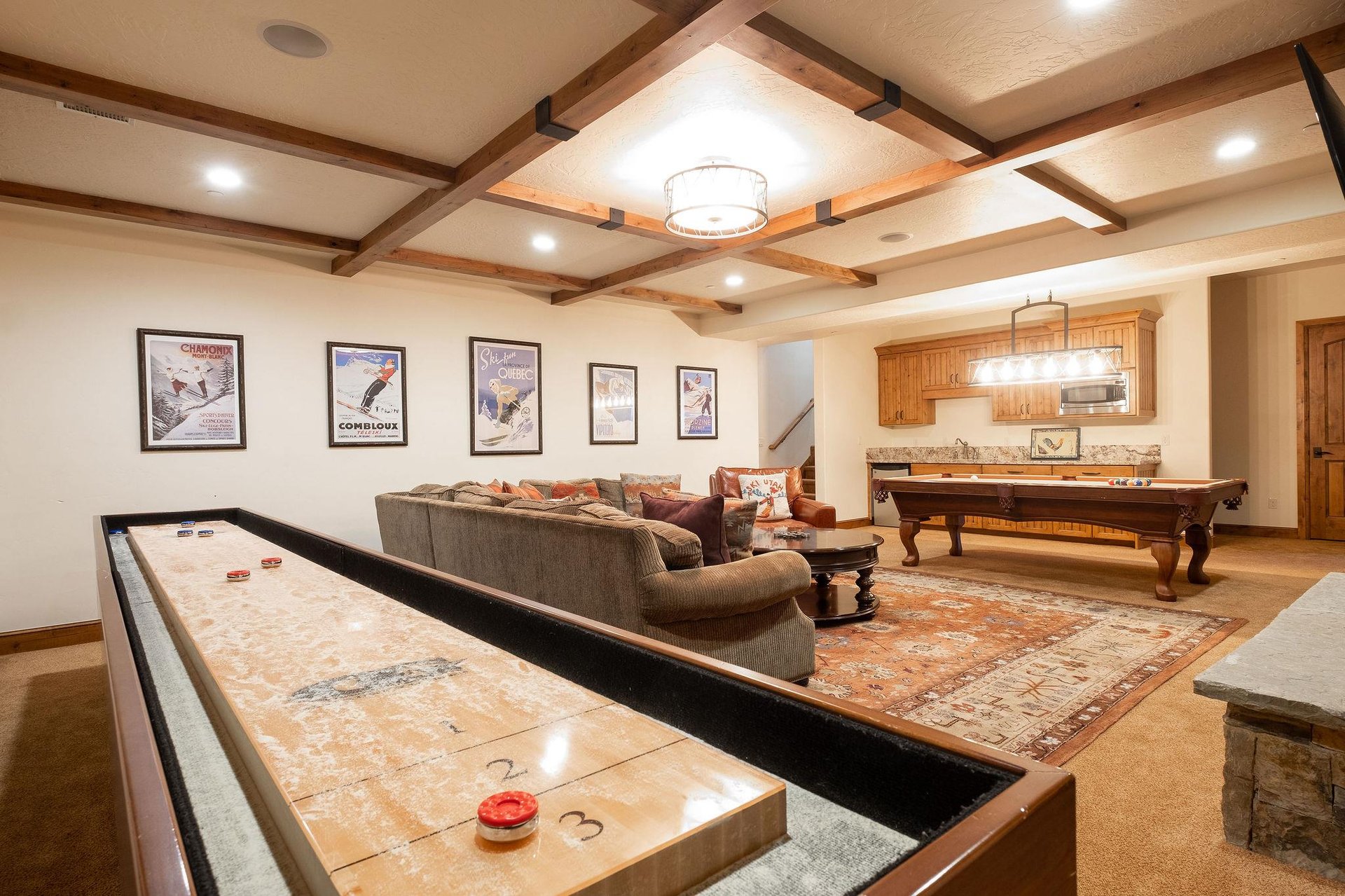 Shuffle board, sectional, and billiards in the game roomden