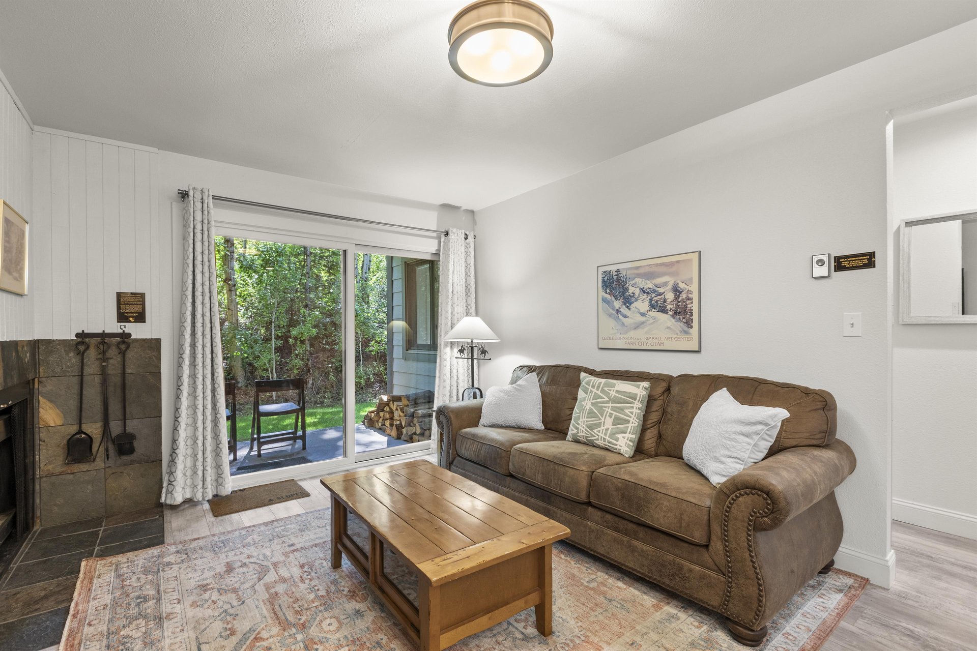 The living room offers a comfortable couch and sliding glass doors leading to a lovely patio.