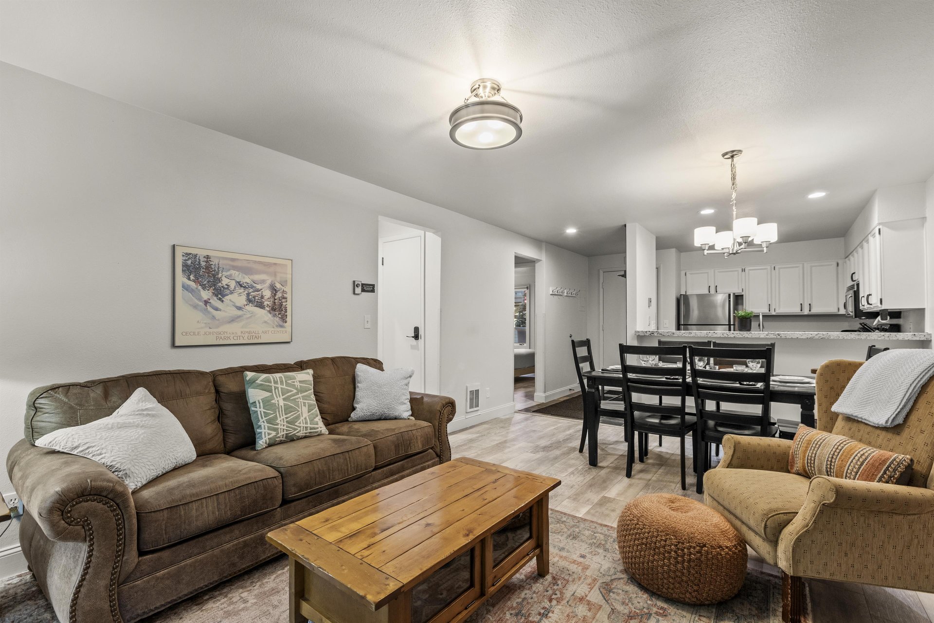 The living room offers a comfortable couch and chair.