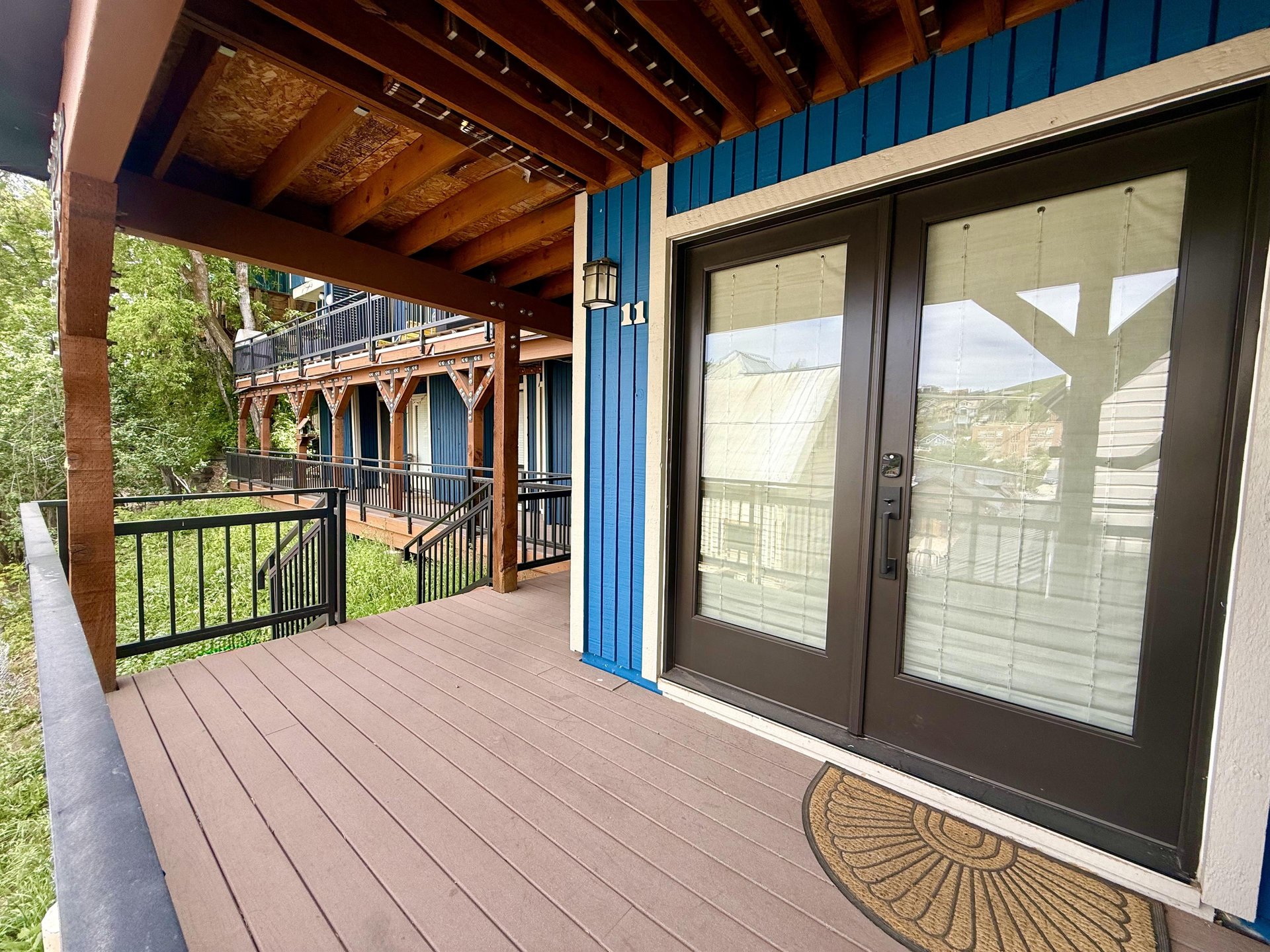 Woodside 11 greets guests with a striking blue exterior and elegant doubledoor entrance.