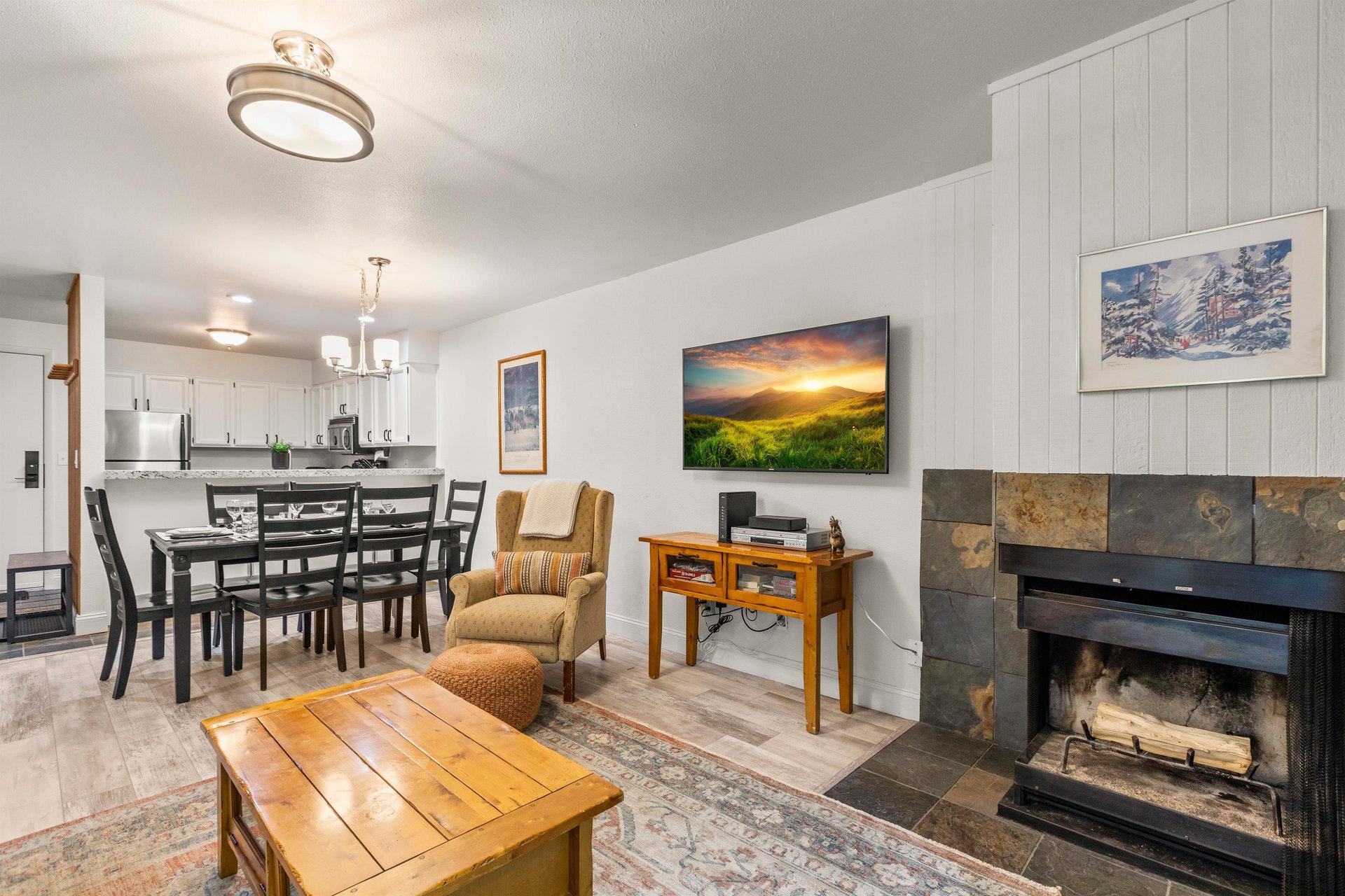 The living room has a wood burning fireplace and flat screen TV.