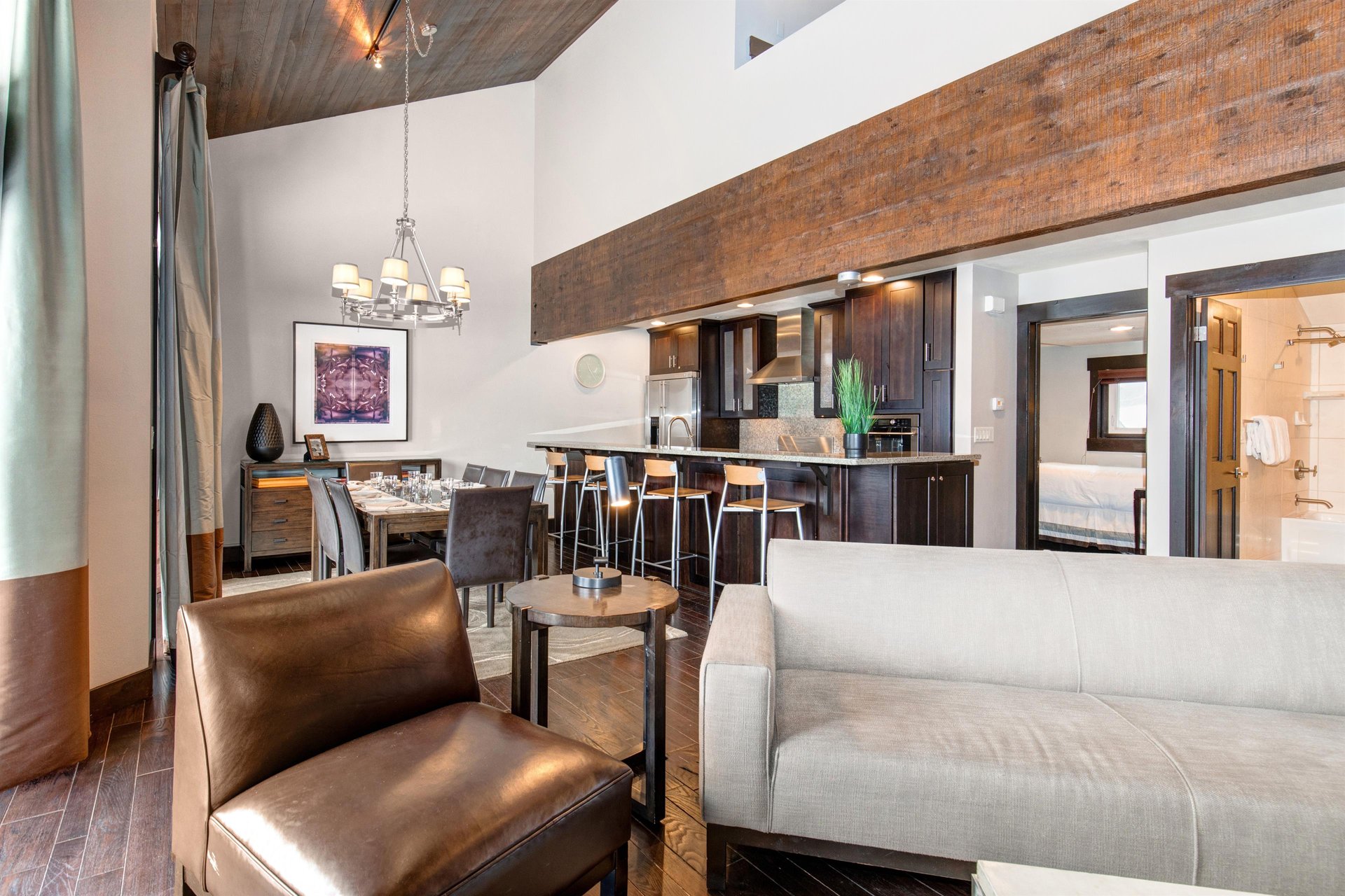 The open concept living room, dining and kitchen area with high ceilings.