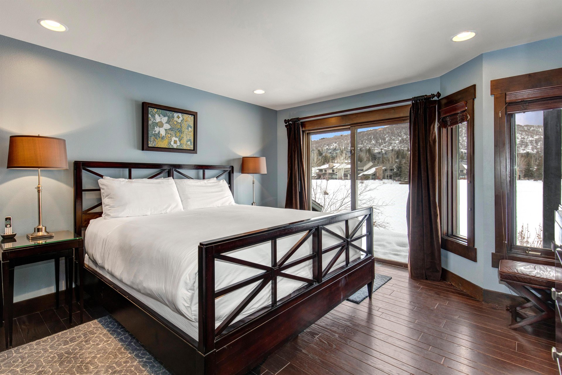 The main suite with a king size bed and large sliding glass door look over the lake and mountains.