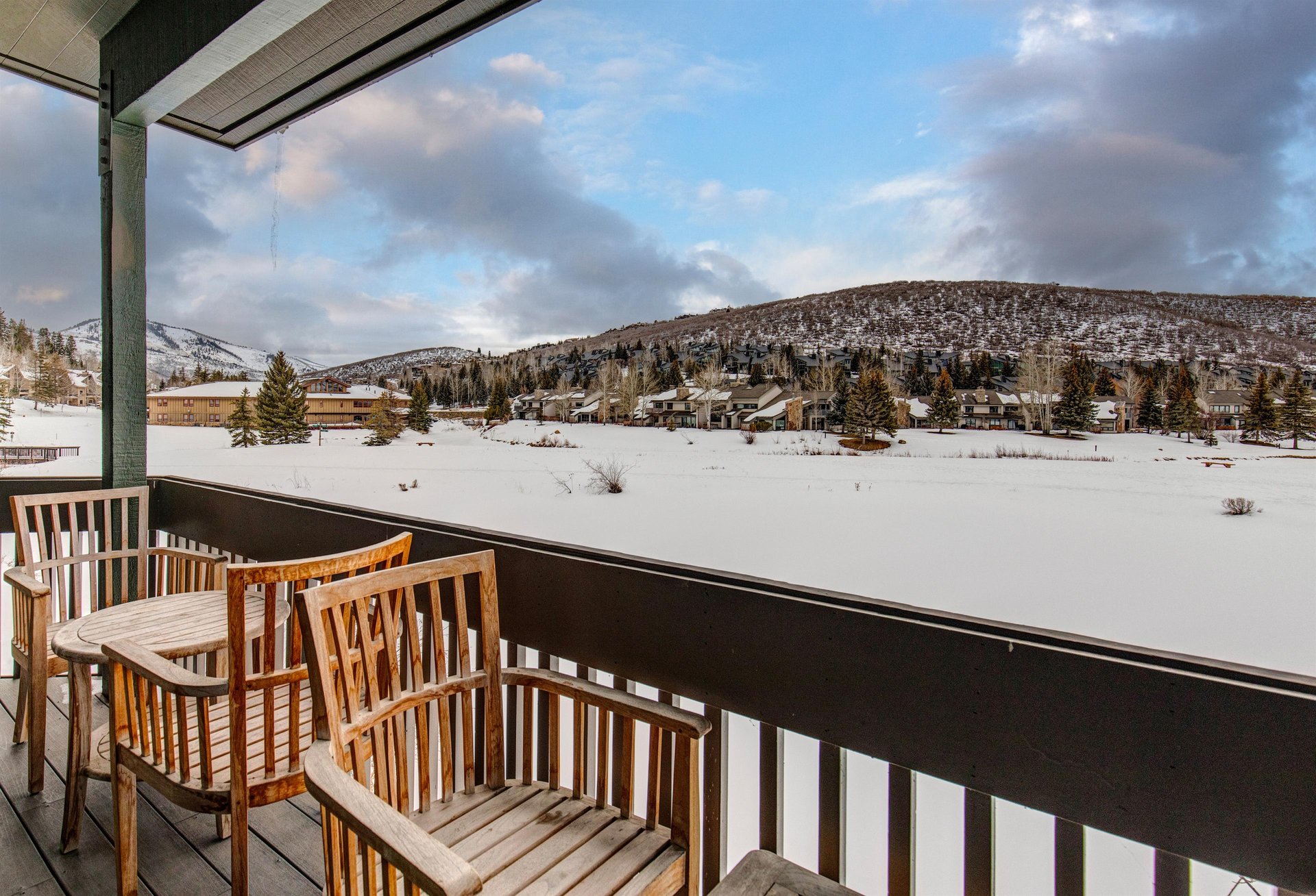A private patio with a table, two chairs and BBQ gas grill where you can take in the mountain and lake views.