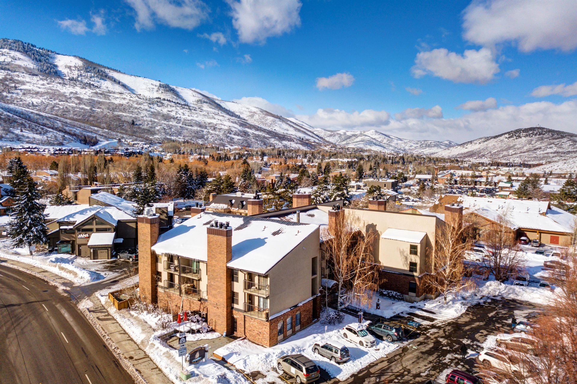 Stunning mountain resort nestled in a pristine winter valley with snowcapped peaks and charming alpine village surroundings.