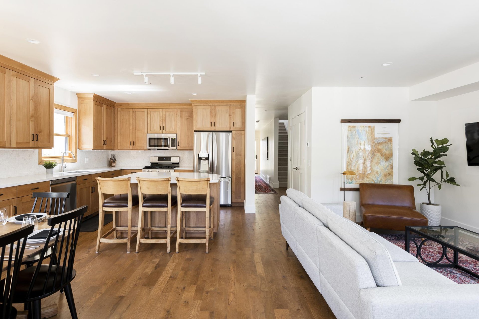 Wood floors throughout the kitchen, dining, and living area