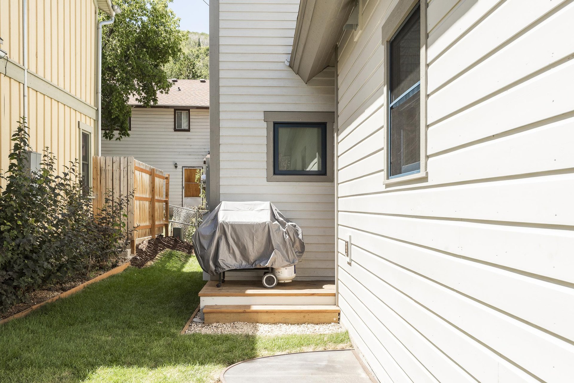 propane grill on the outdoor side patio