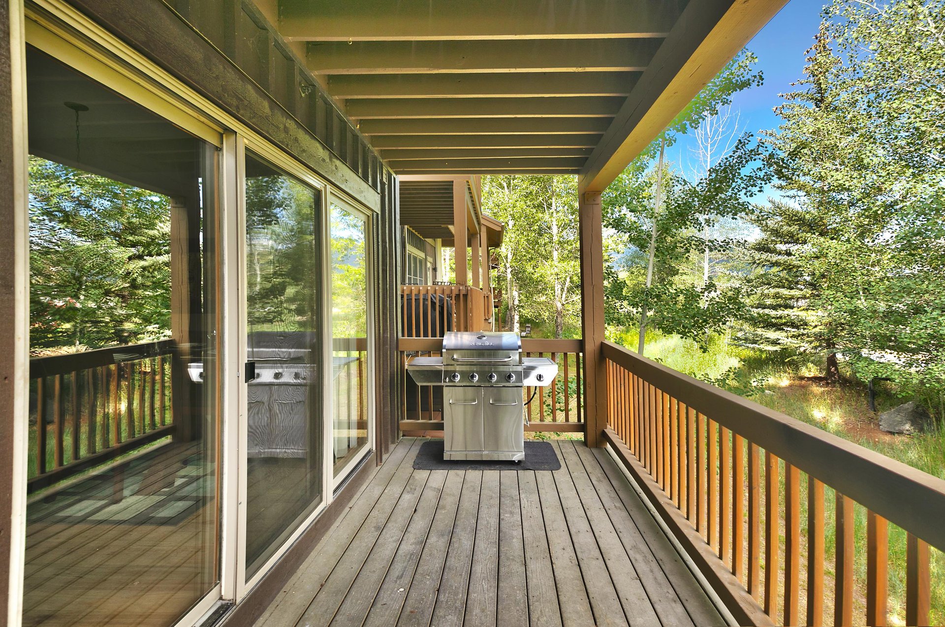 Private patio with chrome gas grill off the main level