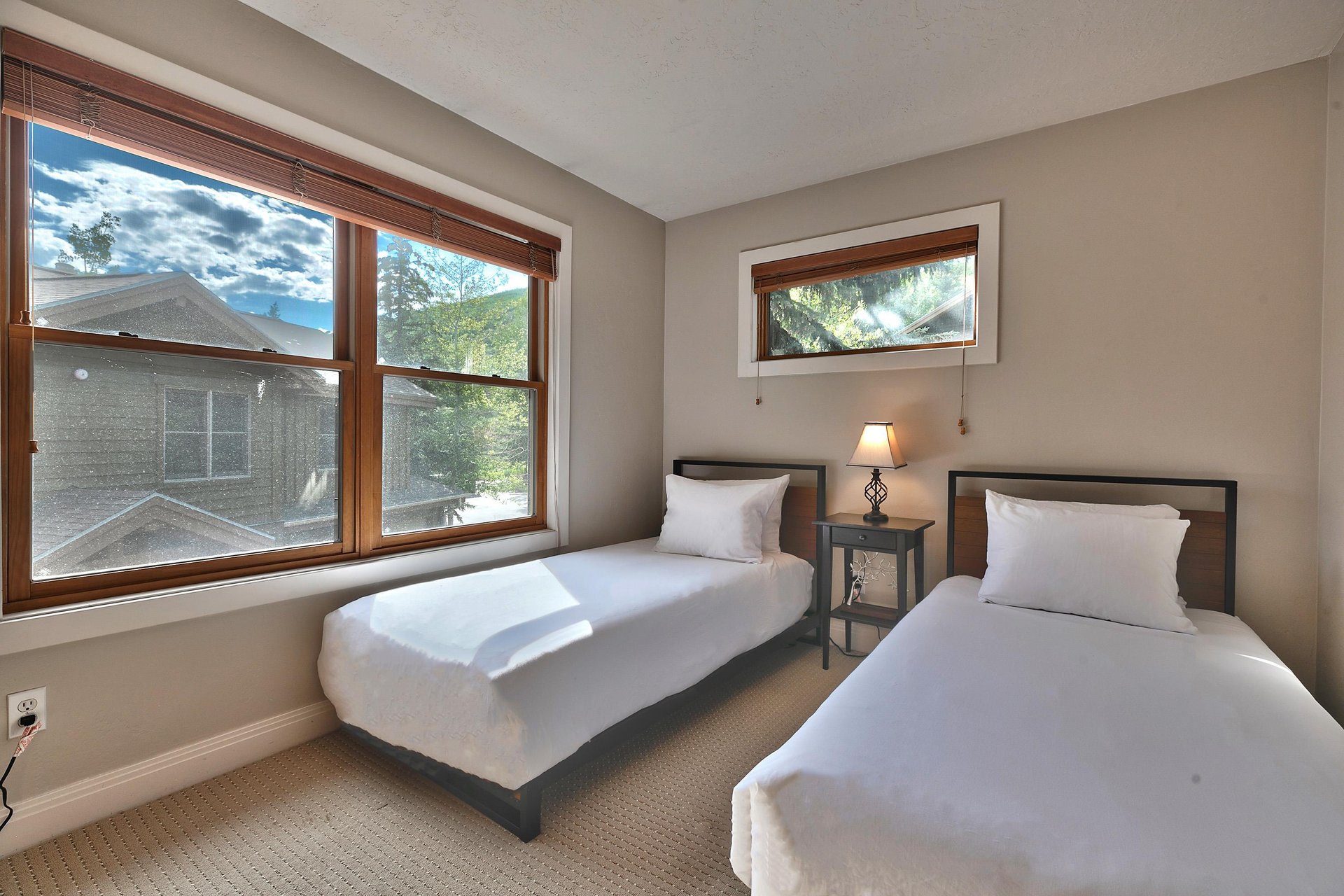 Guest bedroom with two twin beds and large picture window