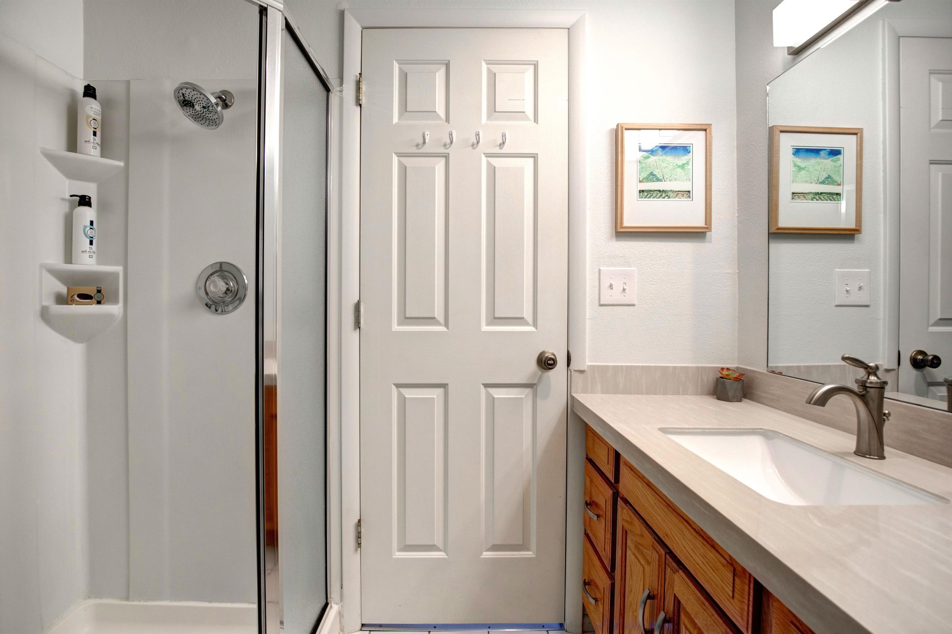 Relax and refresh in your private bathroom with walkin shower, vanity, and thoughtfully arranged amenities for a comfortable stay.