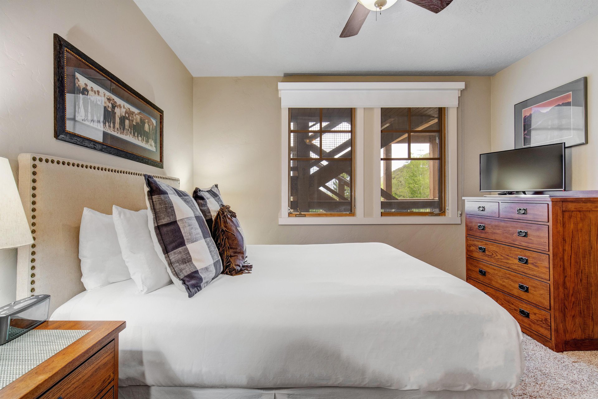 Sink into plush bedding and unwind in your serene bedroom, where warm wood tones and thoughtful touches create the perfect retreat after a day of adventure.