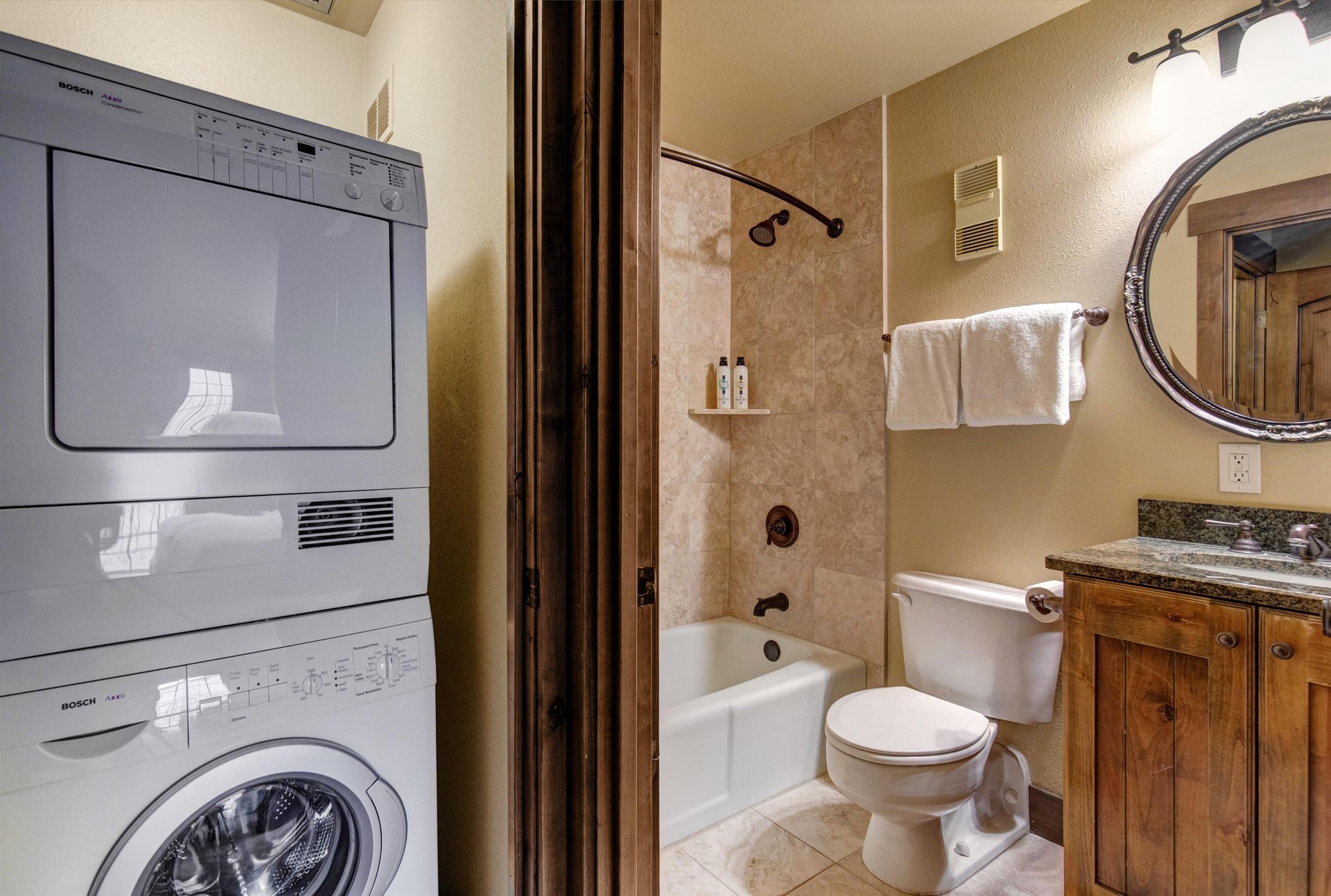 Your private bathroom features a convenient washerdryer combo, granite vanity, and relaxing tubshower combination.