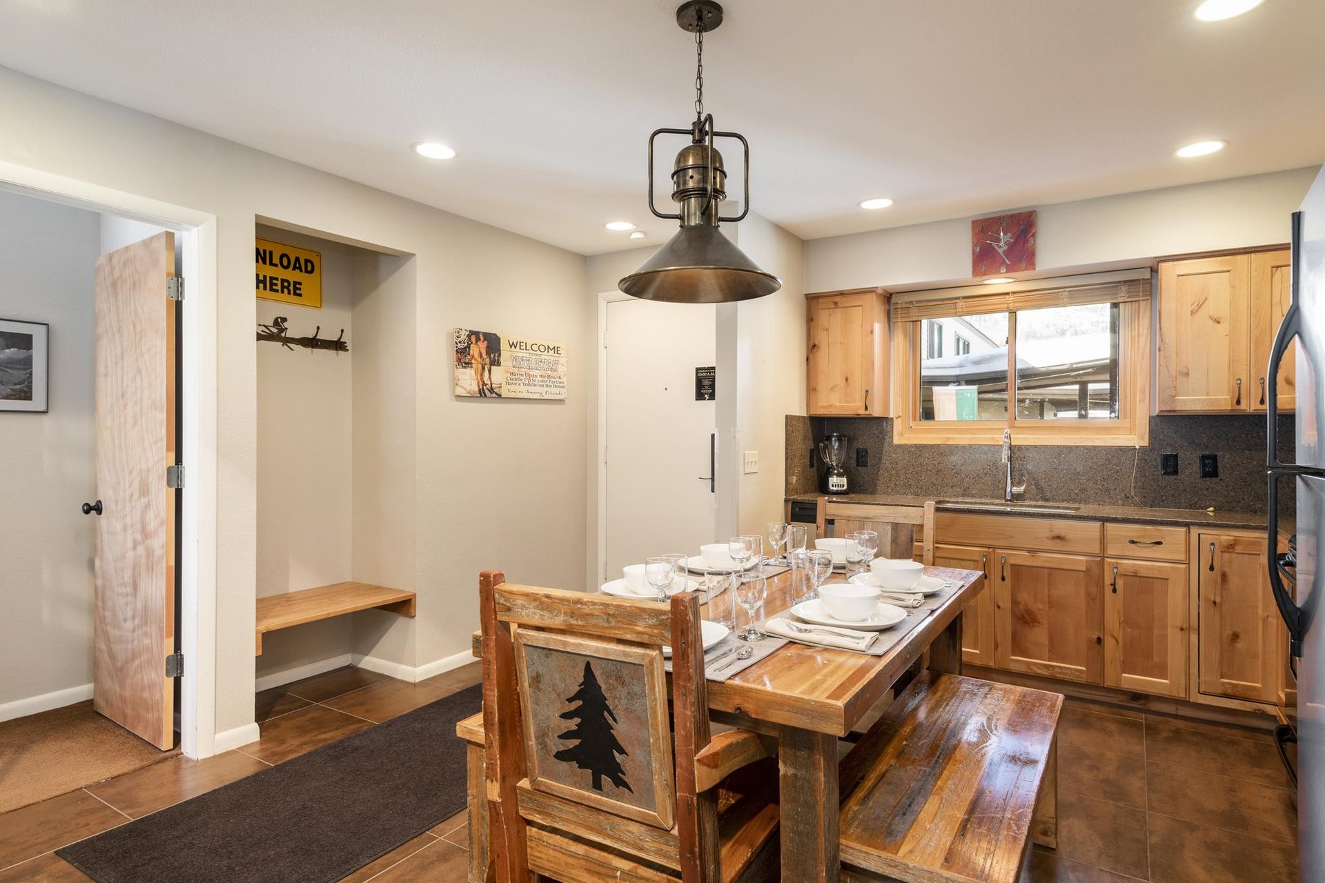 Mountainstyle dining area with solid wood table, bench seating and convenient entryway