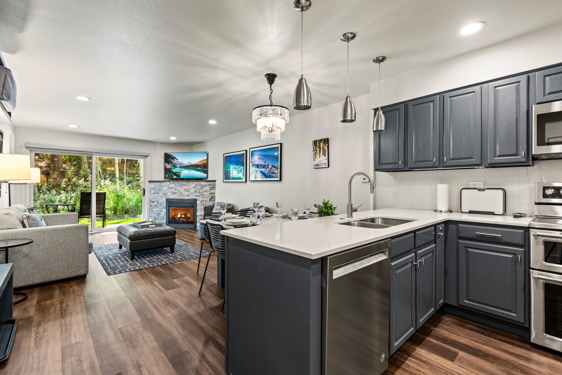 Openconcept Park City condo with modern kitchen, dining area, fireplace and bright living room