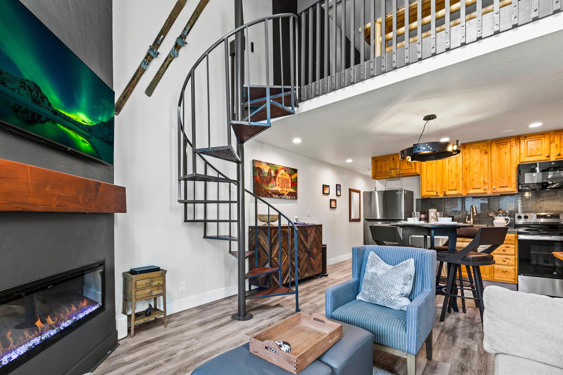The well styled living room with a spiraled staircase.