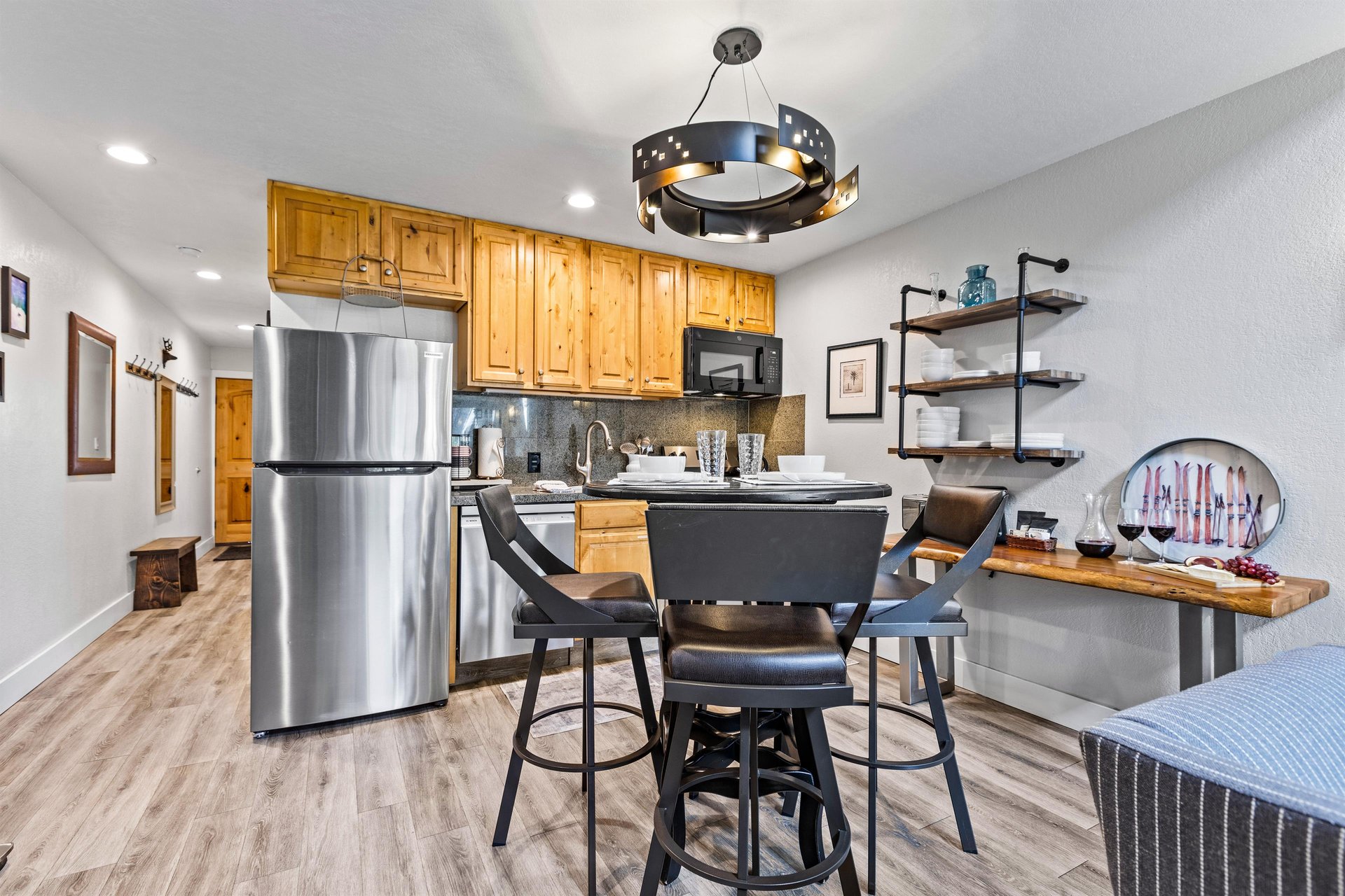The open concept dining and kitchen area with some open shelving on the adjacent wall.
